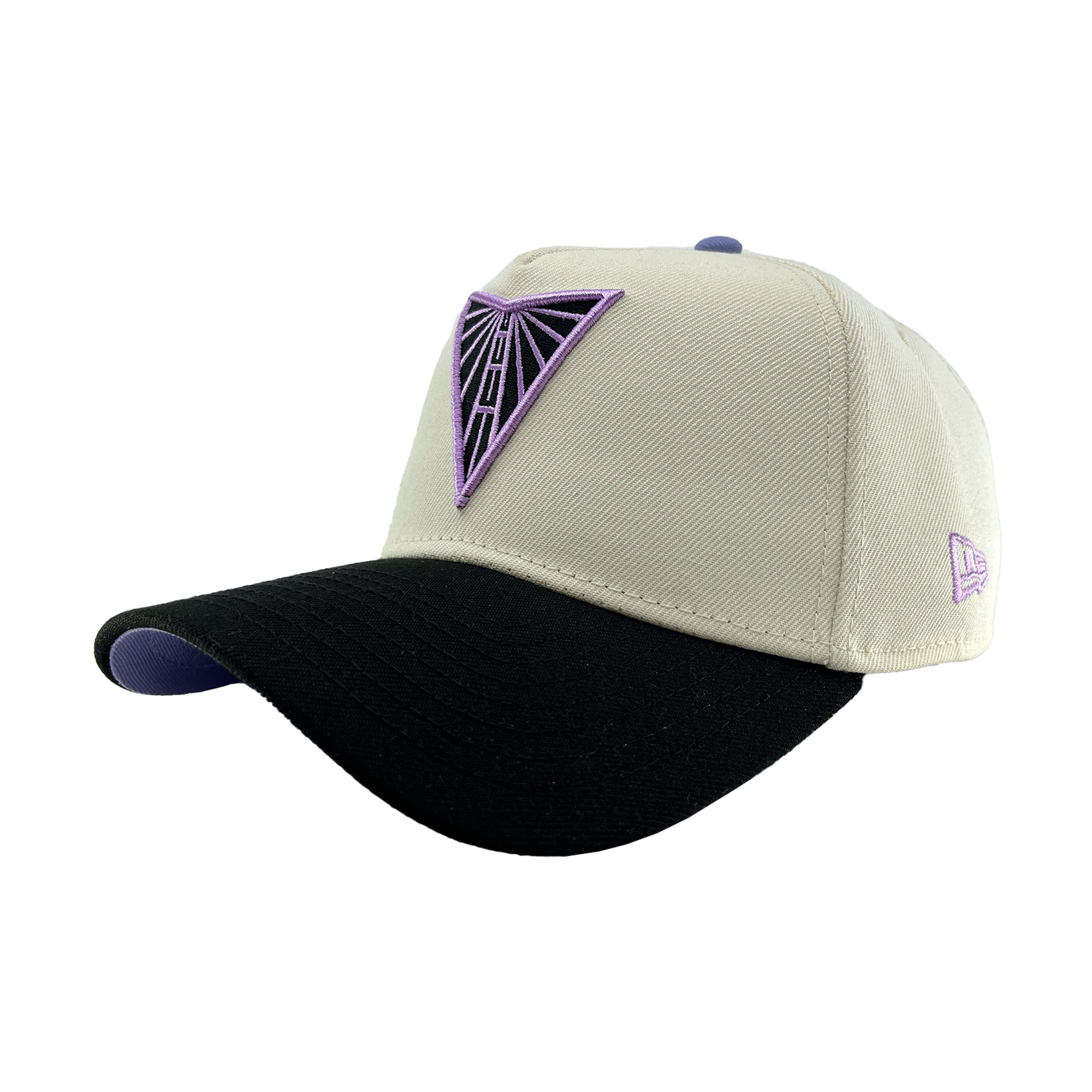 The GSV 9FORTY AF 2 Tone cap by GSV features a beige crown, black curved brim with a purple underside, and purple geometric triangle logo on the front. A small purple logo is stitched on the left side. Adjustable New Era snapback.