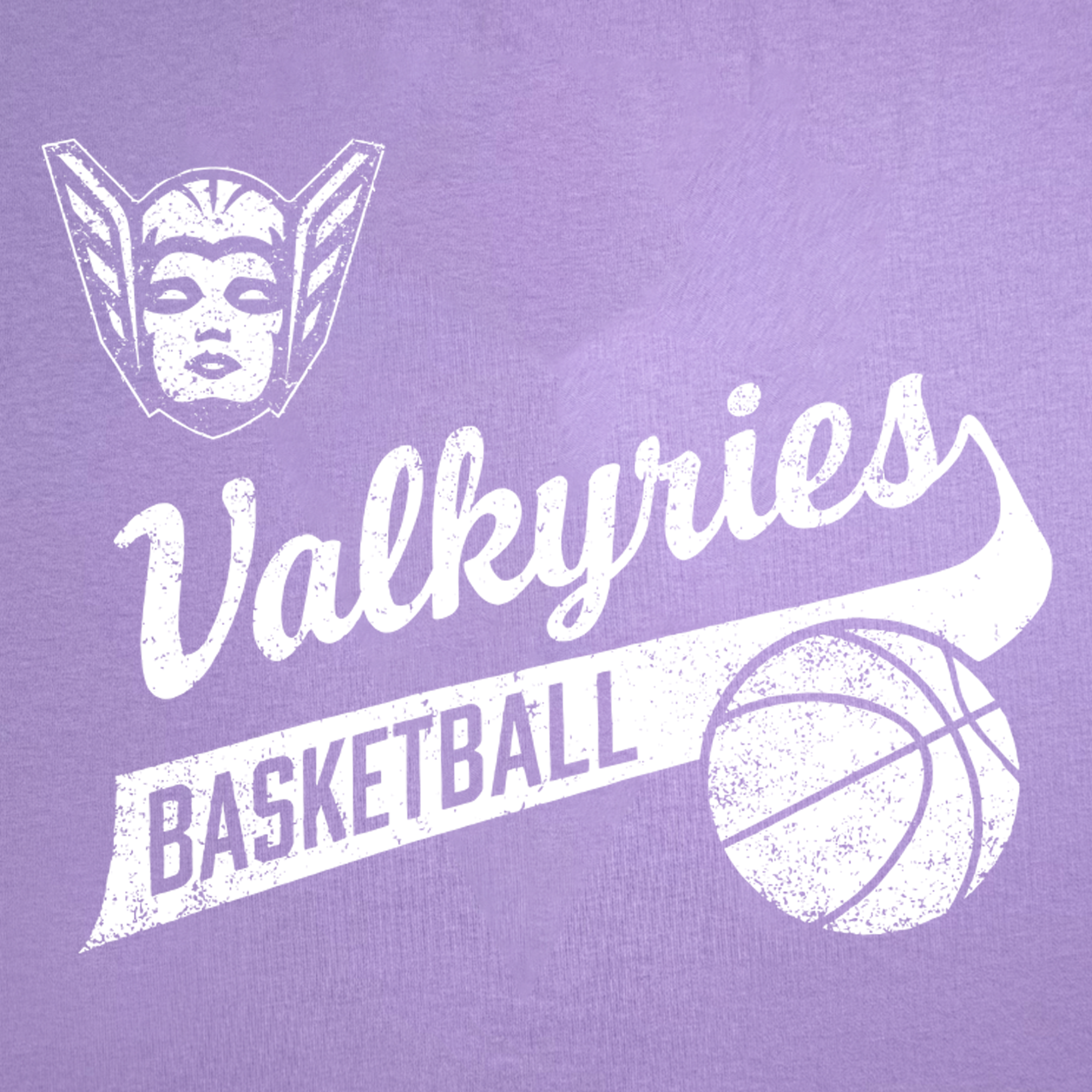 A distressed white graphic featuring a winged, helmeted face, the script word “Valkyries,” “BASKETBALL” in bold block letters on a banner, and a basketball illustration on the right side stands out against a purple background. Printed on GSV’s 100% cotton classic fit GSV Vintage Tee, this design captures the spirit of the Golden State Valkyries.