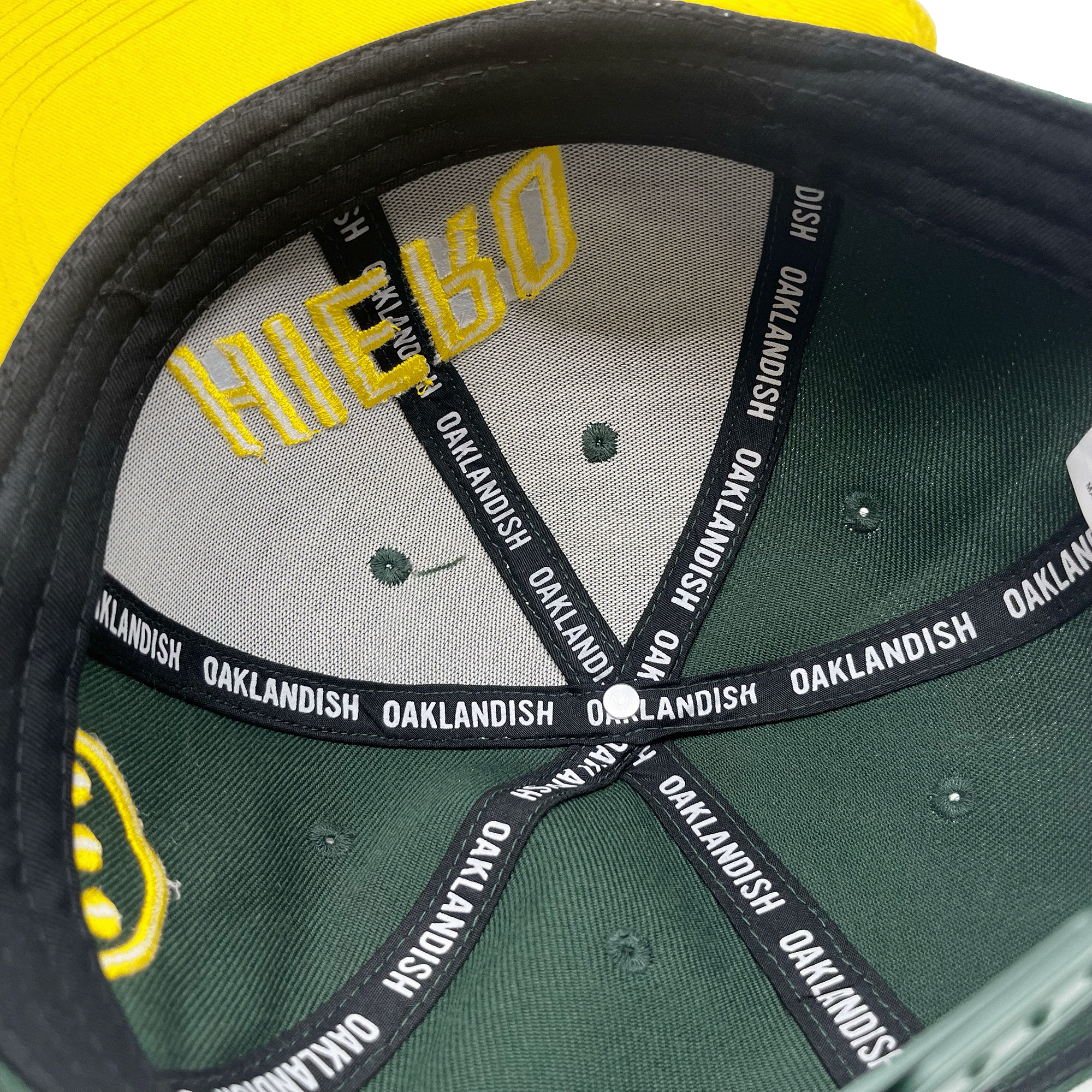 Inside view of the crown of a cap with OAKLANDISH taping inside the crown.
