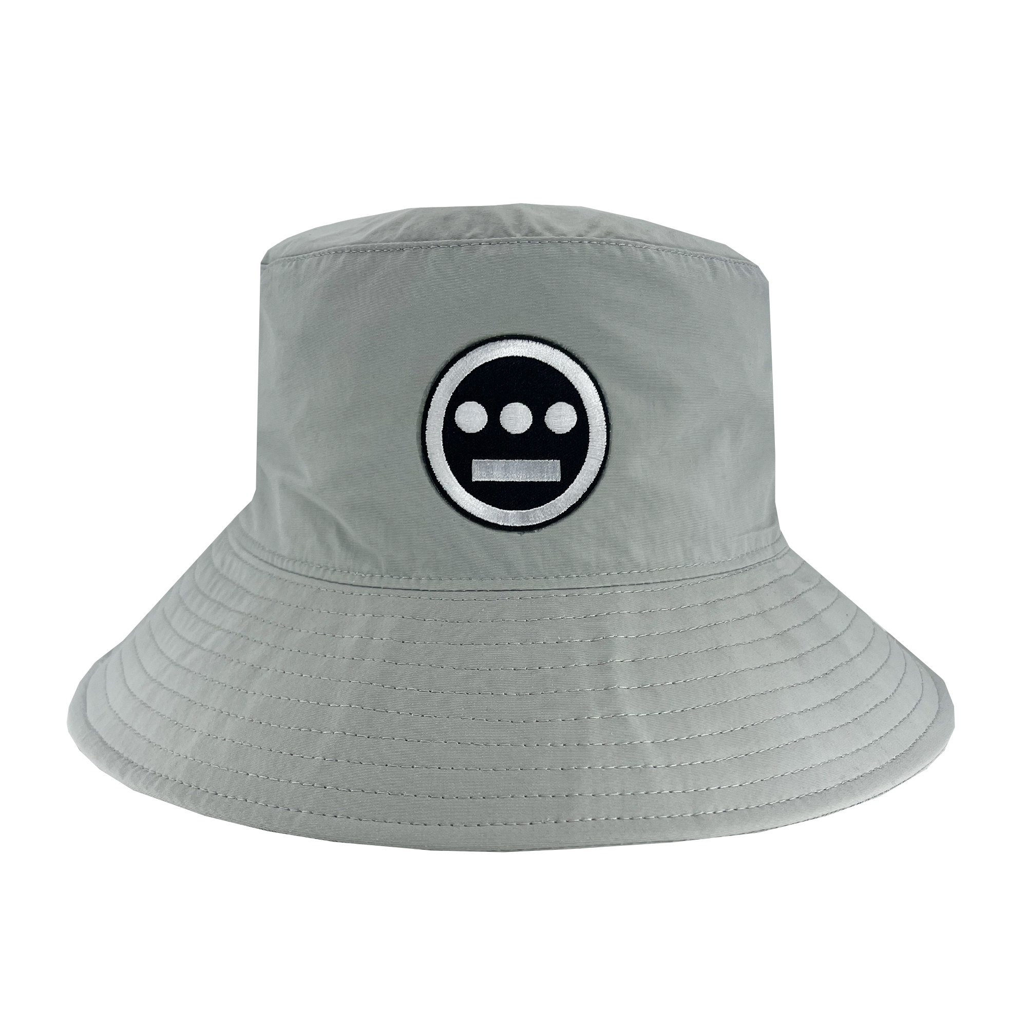 Wide brim grey bucket hat with toggles and Hiero logo patch .