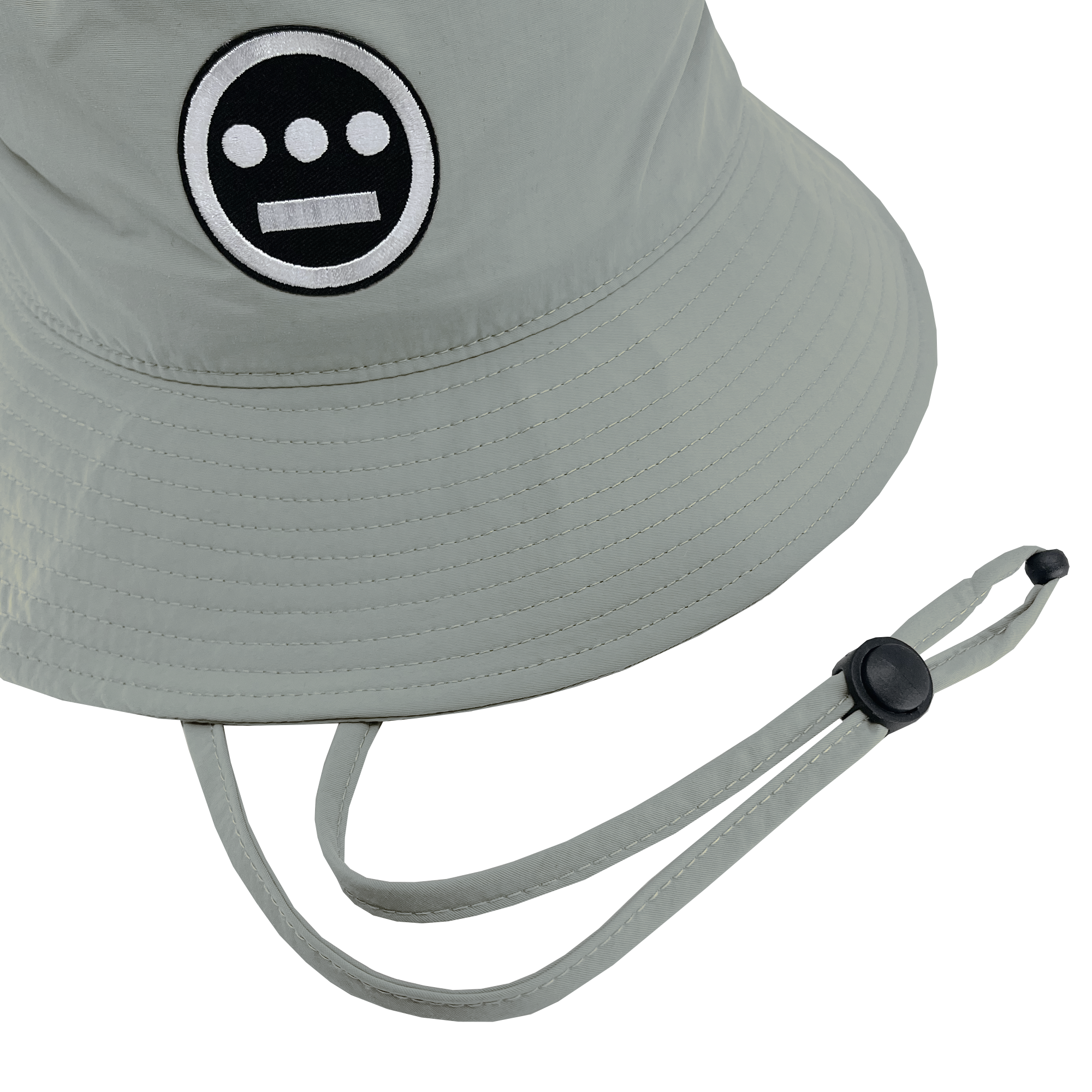 Detailed view of wide brim grey bucket hat with toggles and Hiero logo patch .