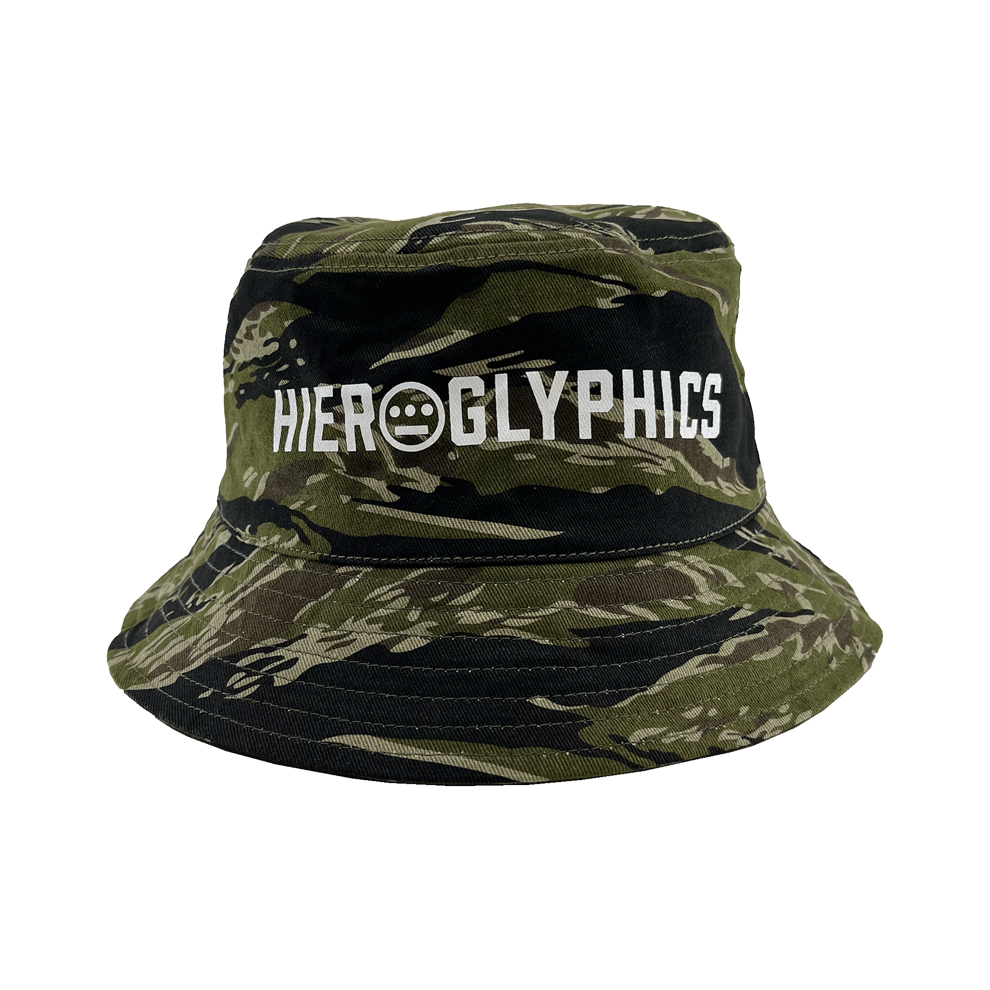 The Hieroglyphics Hiero Reversible Camo Bucket is a camouflage bucket hat featuring a green and black tiger camo pattern. The front displays the word "HIEROGLYPHICS" in white, along with a small circular symbol consisting of three dots over a horizontal line within a circle, directly beneath the word.