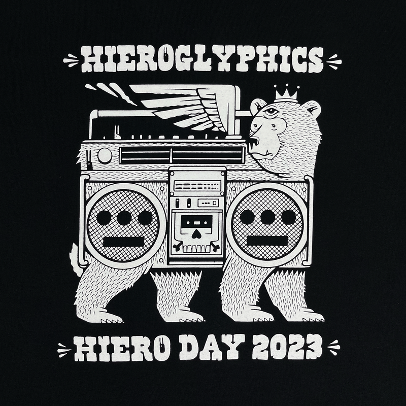 Close-up of white Hieroglyphics Hiero Day 2023 graphic on a black t-shirt.