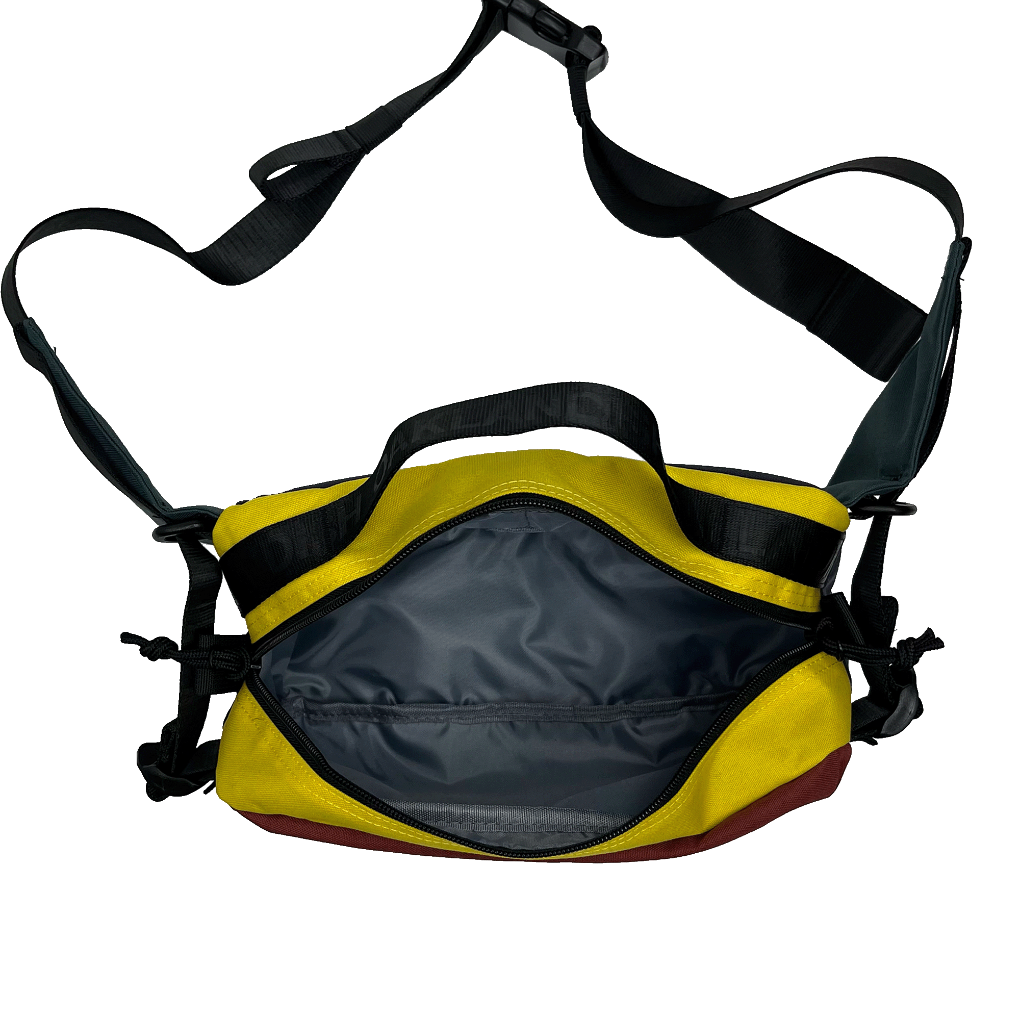 Top view of the cross-body bag with yellow color block and open zipper to reveal  nylon lined insides.