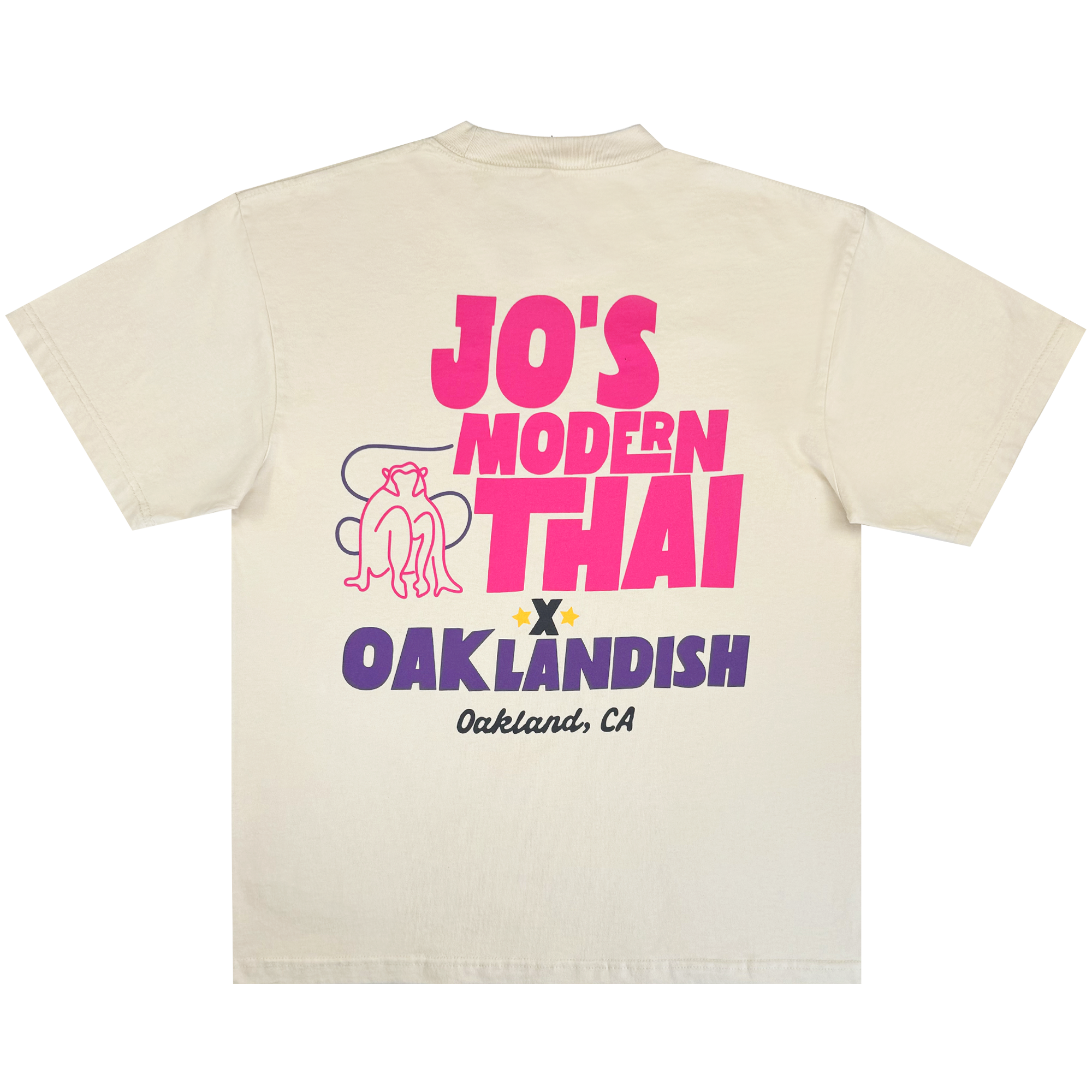 The Jo's Modern Thai X Oaklandish Tee by Oaklandish is a cream heavy-weight t-shirt showcasing bold “JO’S MODERN THAI” text, a reclining dog graphic, and “OAKLANDISH Oakland, CA” on the back—a special collaboration piece.