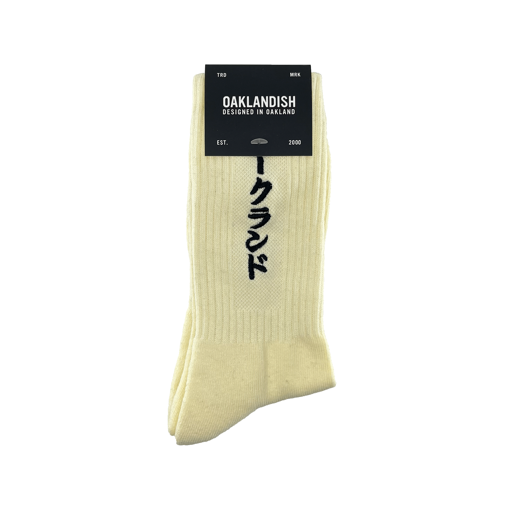 Pair folded white crew socks in Oaklandish packaging with a black embroidered Kanji Japanese script wordmark on the sock.