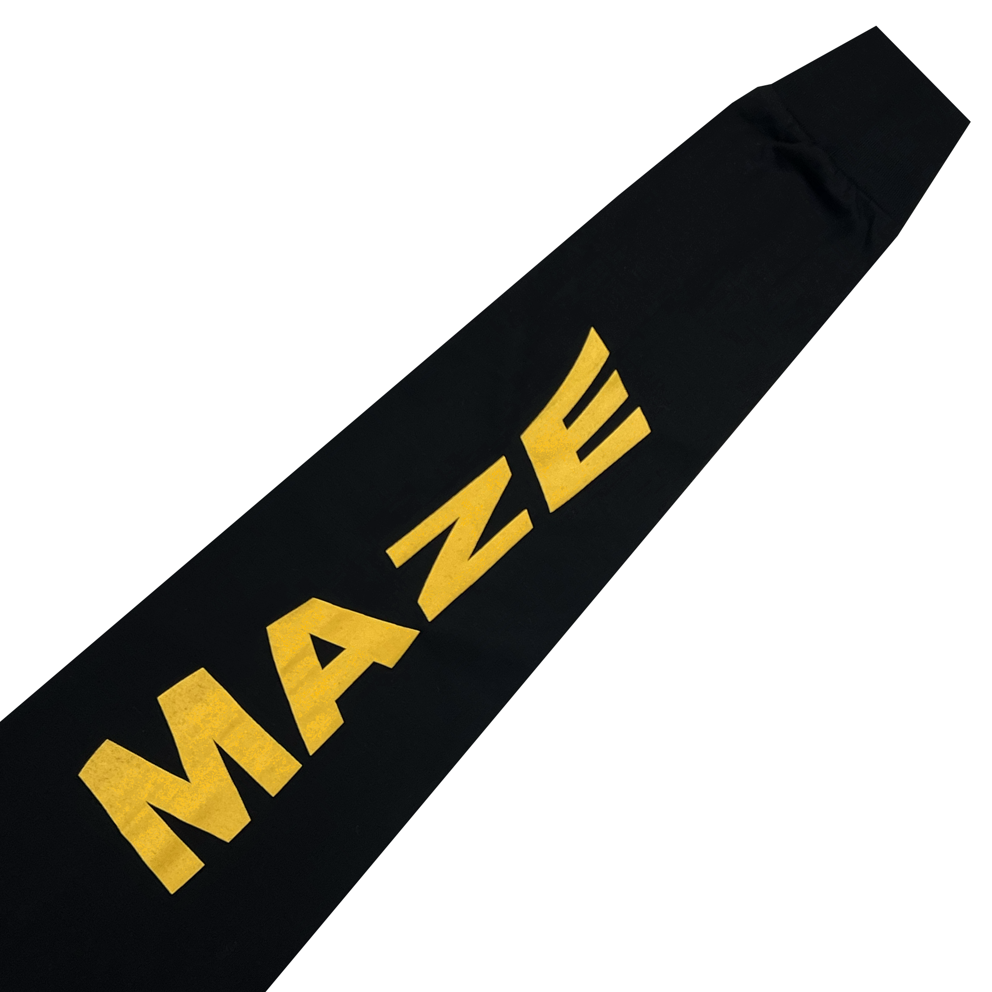 A close-up view of the "MacArthur Maze x Oaklandish LS Tee" by Oaklandish. This black, long sleeve t-shirt features the word "MAZE" printed in large, bold, yellow uppercase letters running diagonally from the bottom left to the top right on the sleeve. The fabric appears to be smooth and slightly wrinkled.