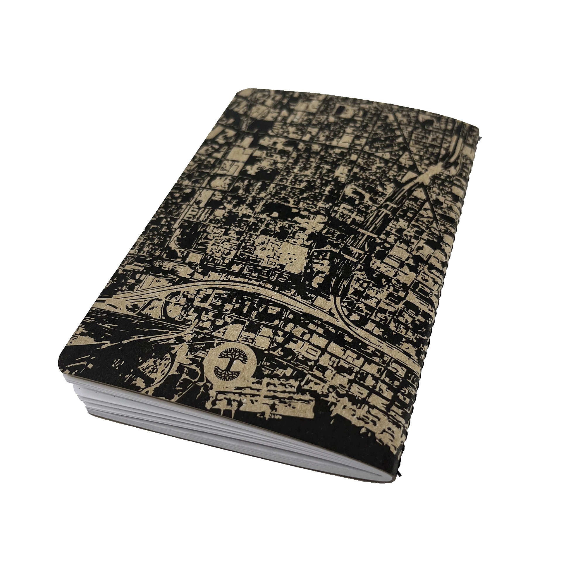 The Aerial Map Mini Notebook by Never Elsewhere features an intricate beige city map design on its letterpress cover. The black mini notebook, slightly angled to showcase its thickness, is set against a white background. The detailed map artwork, depicting streets and buildings, imparts a sophisticated urban aesthetic to the notebook.