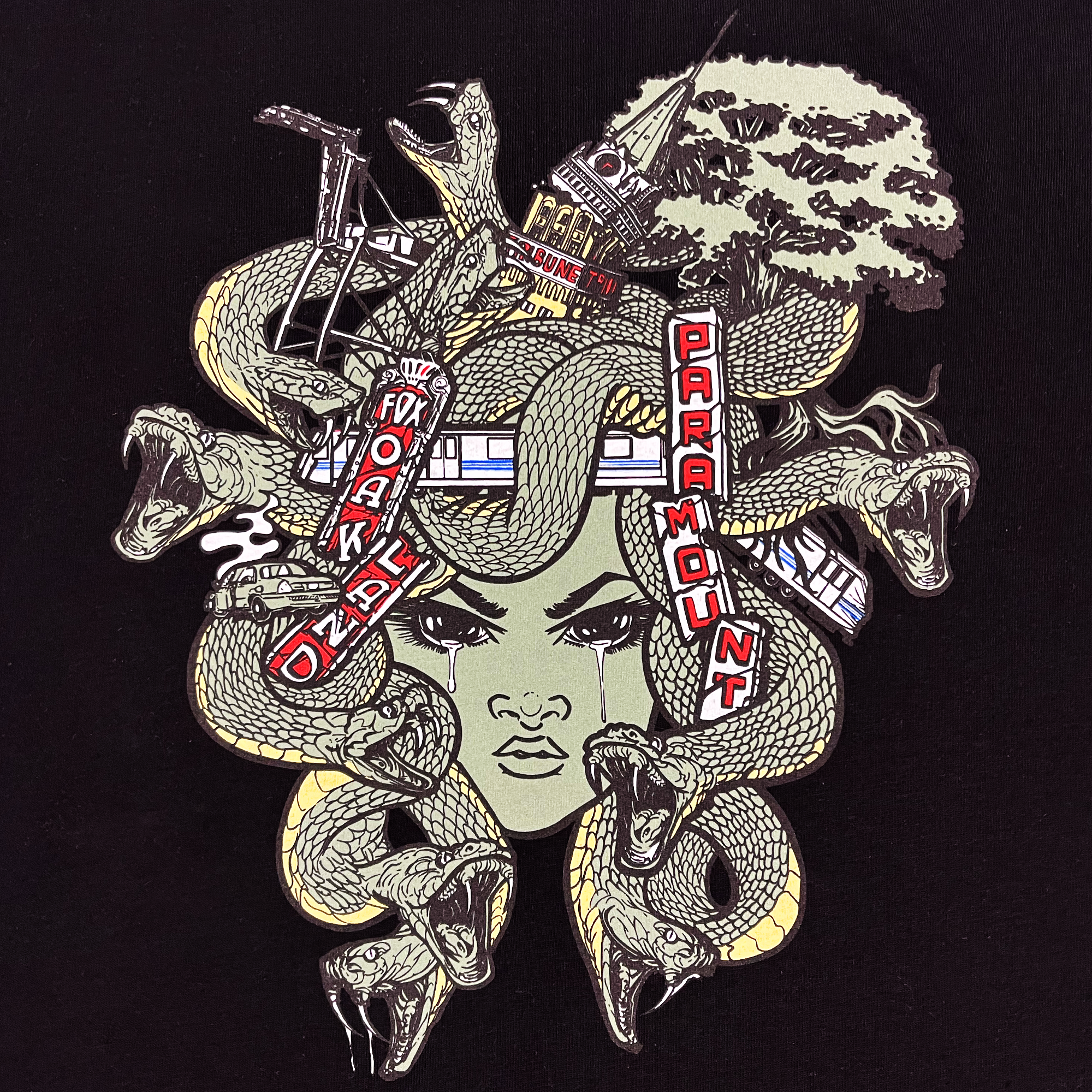 Detailed close-up of Medusa monster of the mind graphic on the front chest of a black-shirt.