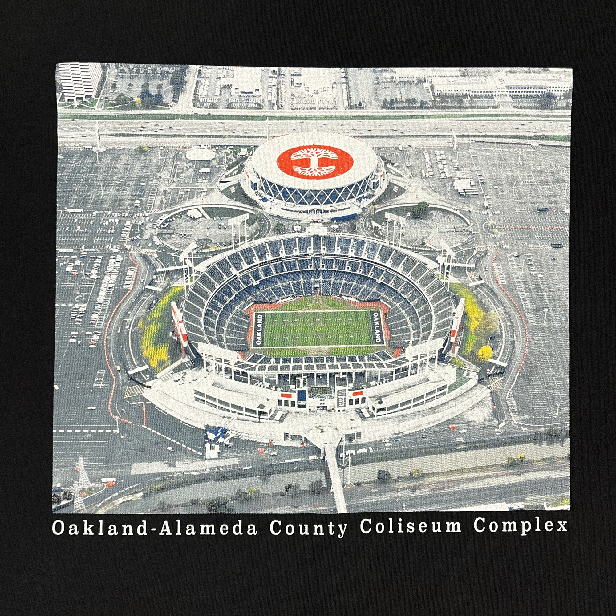Close-up picture of Oakland Alameda County Coliseum Complex on front chest of black t-shirt..