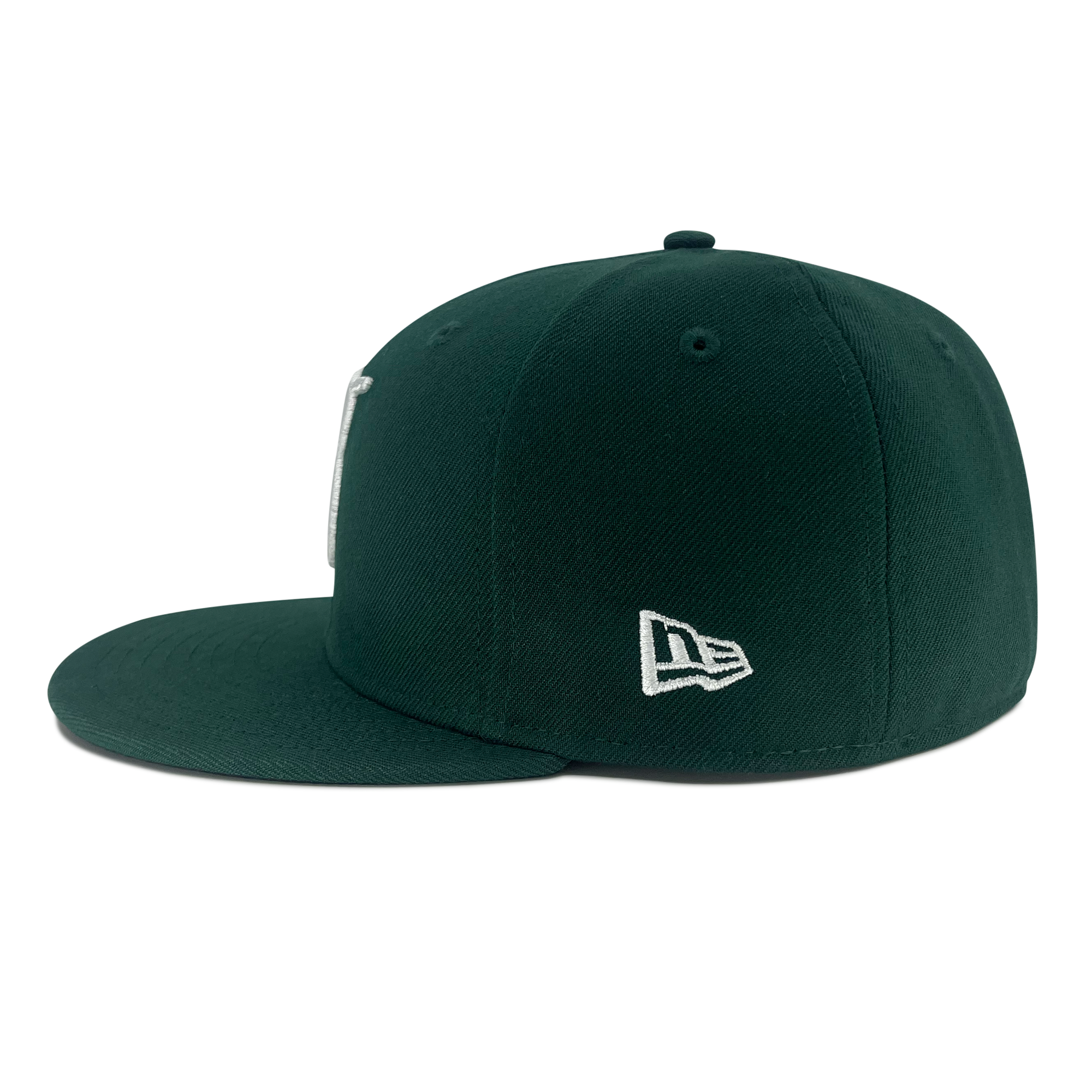 Left side view of forest green 59fifty fitted hat with New Era flag logo  on wearer's left side.