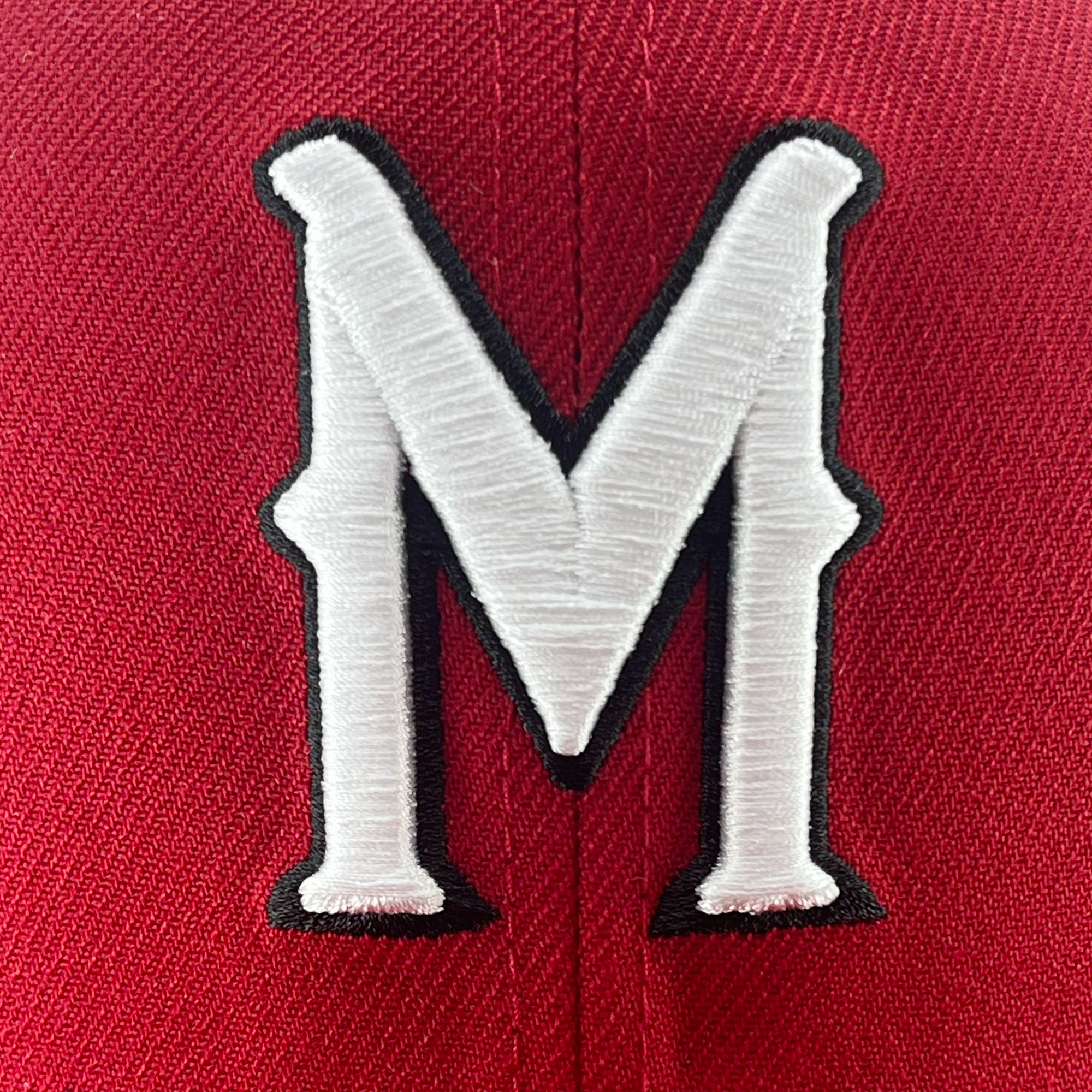 Detailed view of red 59fifty fitted hat with Diablos logo in white embroidery.