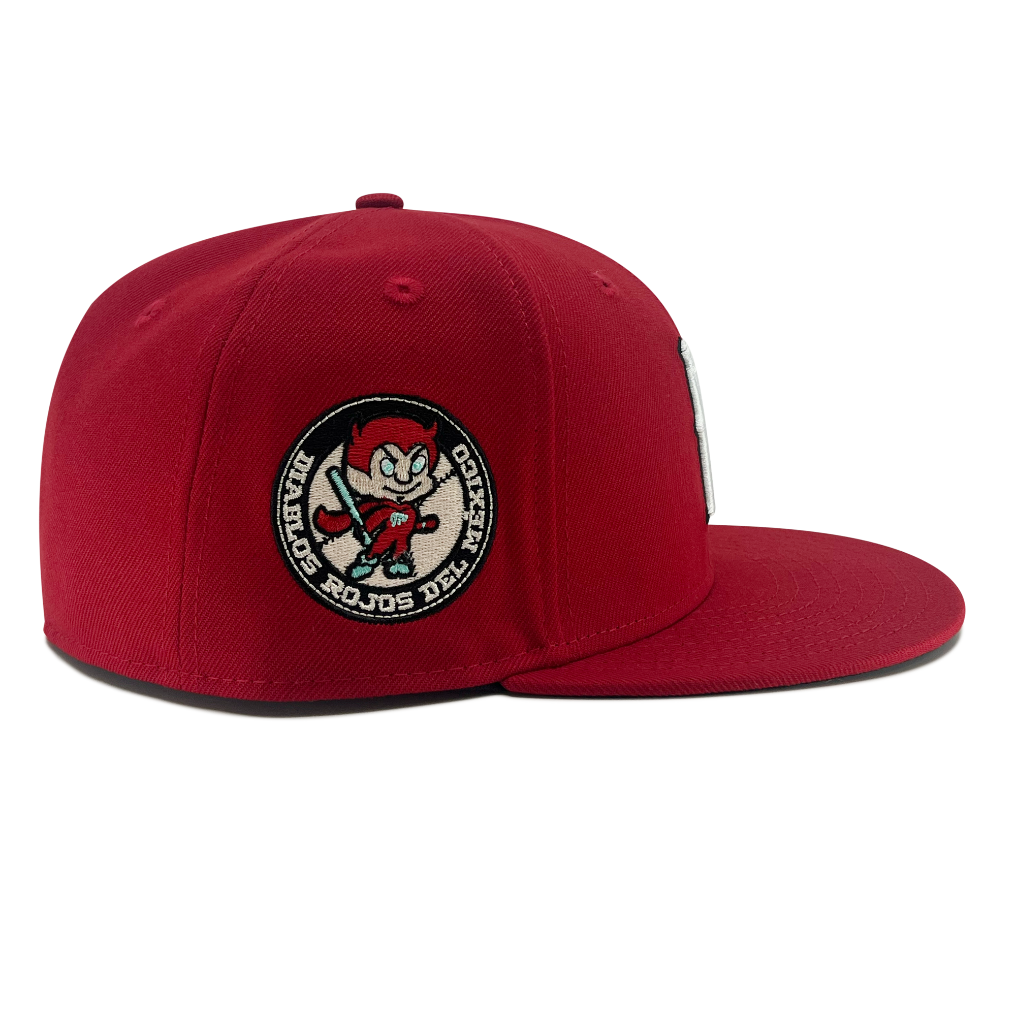 Right side view of red diablos 59fifty  fitted hat with Diablos patch on wearer's right.