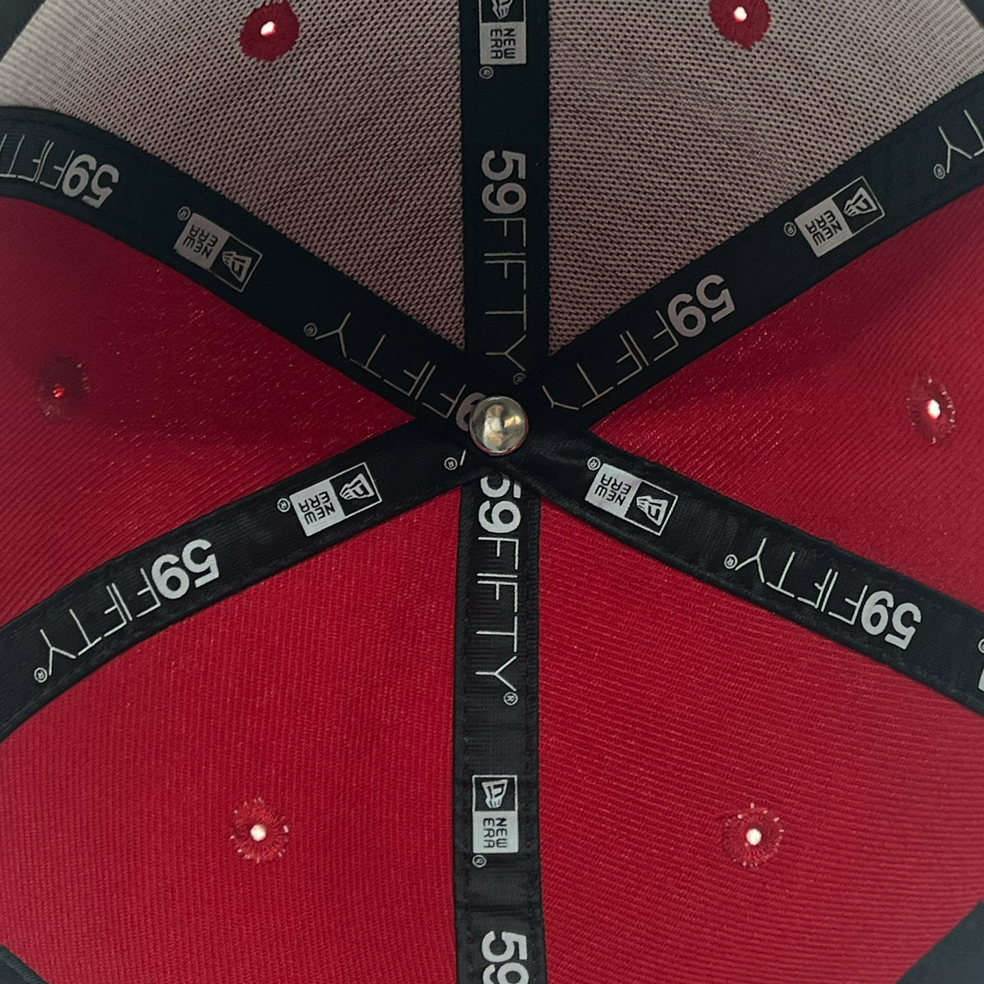 Inside view of red 59fifty fitted hat with new era taping.