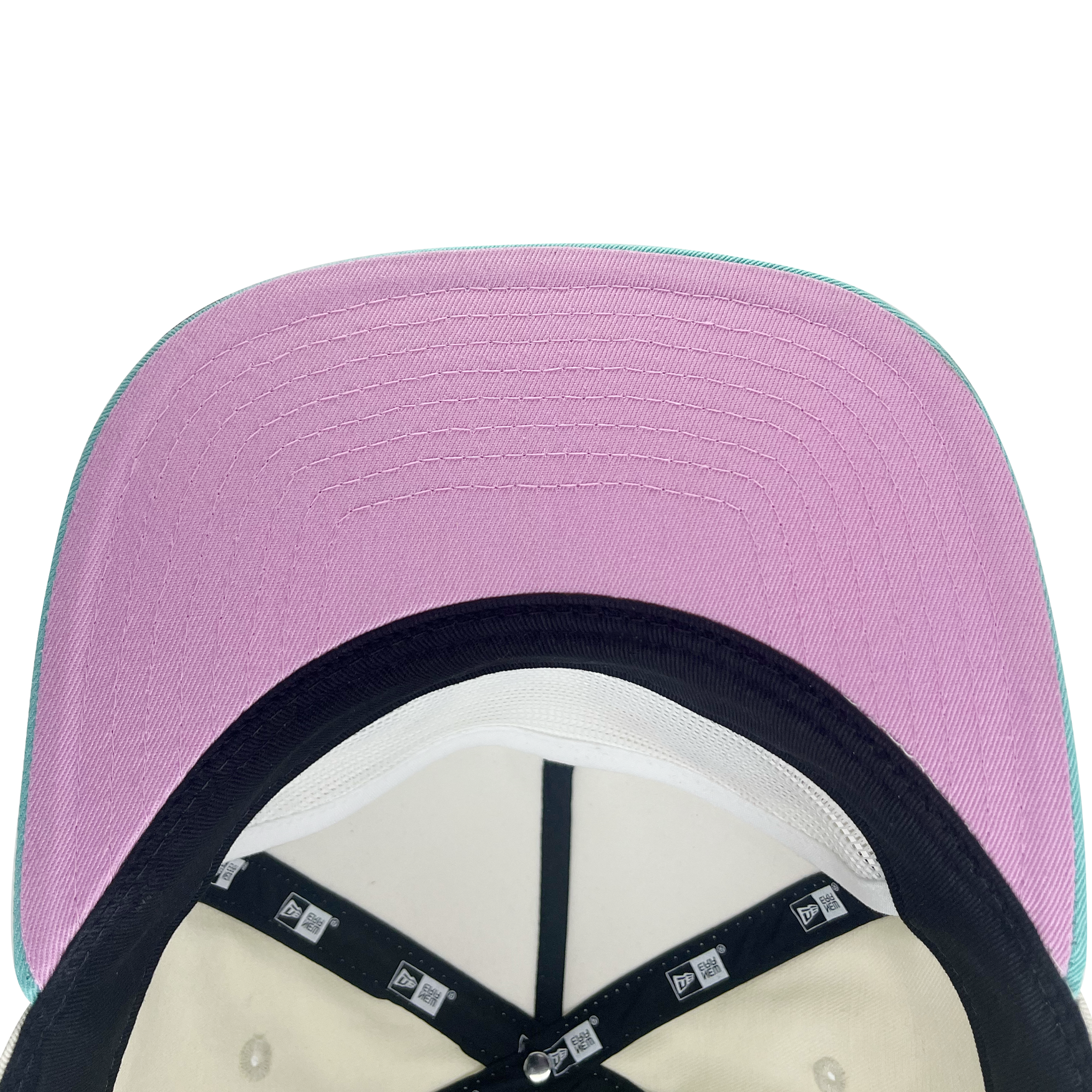 Inside and pink under bill view of cream New Era golfer hat with embroidered Mexico and floral design.