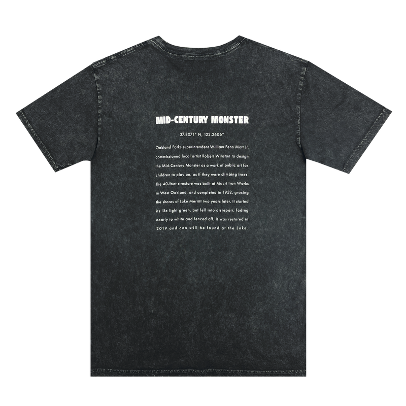 The backside of a black stone-colored t-shirt with long-form text explaining the history of the mid-century monster structure at Oaklands Marci Iron Works.