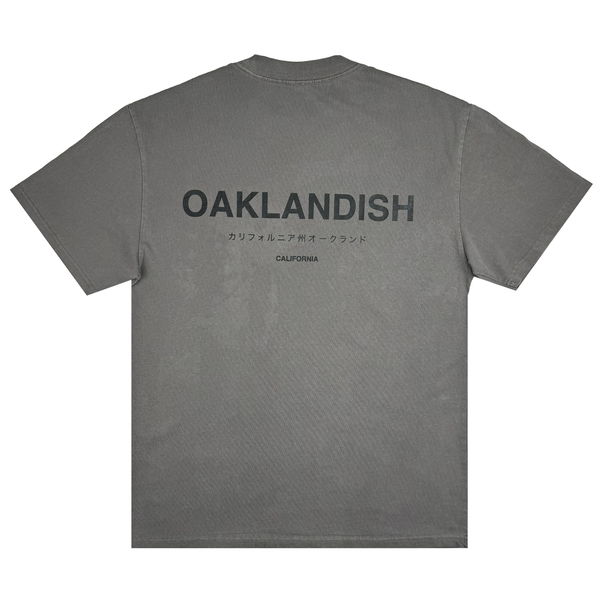 The Modern Type Heavy Tee by Oaklandish is a gray heavyweight T-shirt featuring "OAKLANDISH" printed in bold black letters on the back, with smaller Japanese text accompanying it. Below that is the word "CALIFORNIA." Crafted from 100% carded cotton, this shirt offers a boxy fit and is presented laid flat against a plain white background.