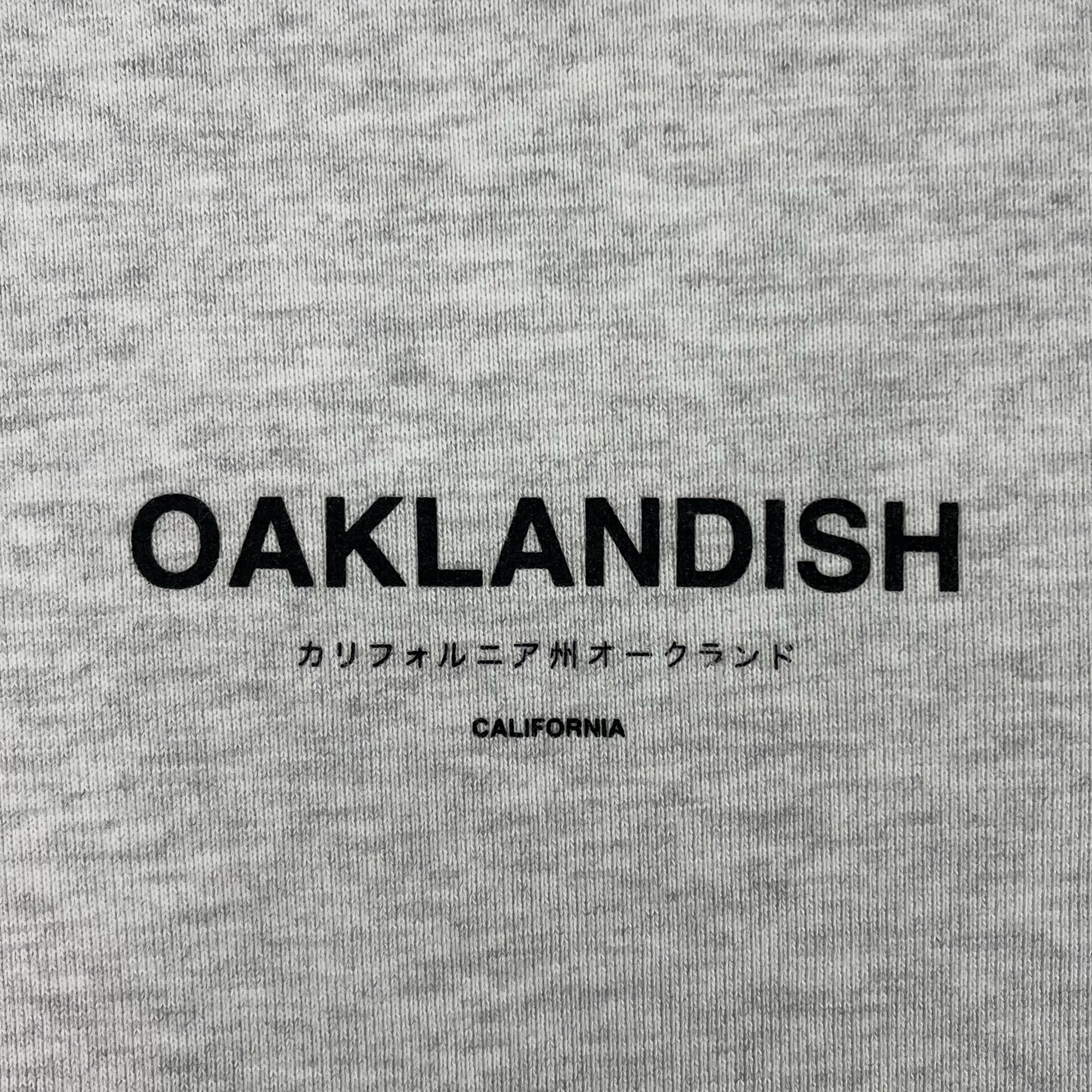 Detailed view of Oaklandish California wordmark in English and Japanese near left pocket.