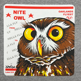 Close-up a graphic with a Burrowing Owl designed by Oakland Artist Nite Owl on a USPS sticker on a grey t-shirt.