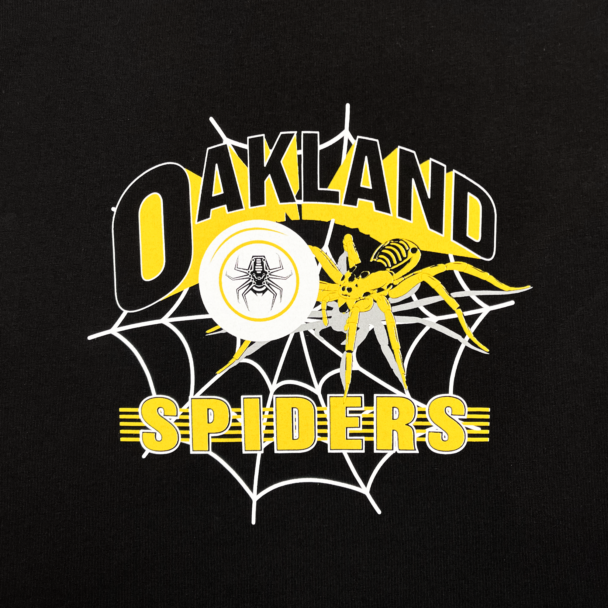 The Oakland Spiders Youth Tee by Supported Brands displays a vibrant graphic design showcasing the words "Oakland Spiders" in yellow and white on a black background. The design features an elaborate spider web with a detailed yellow spider, accompanied by a circular image of a black spider at its center. Yellow and white lines highlight the Ultimate Frisbee team's dynamic logo, adding to the tee's energetic appeal.