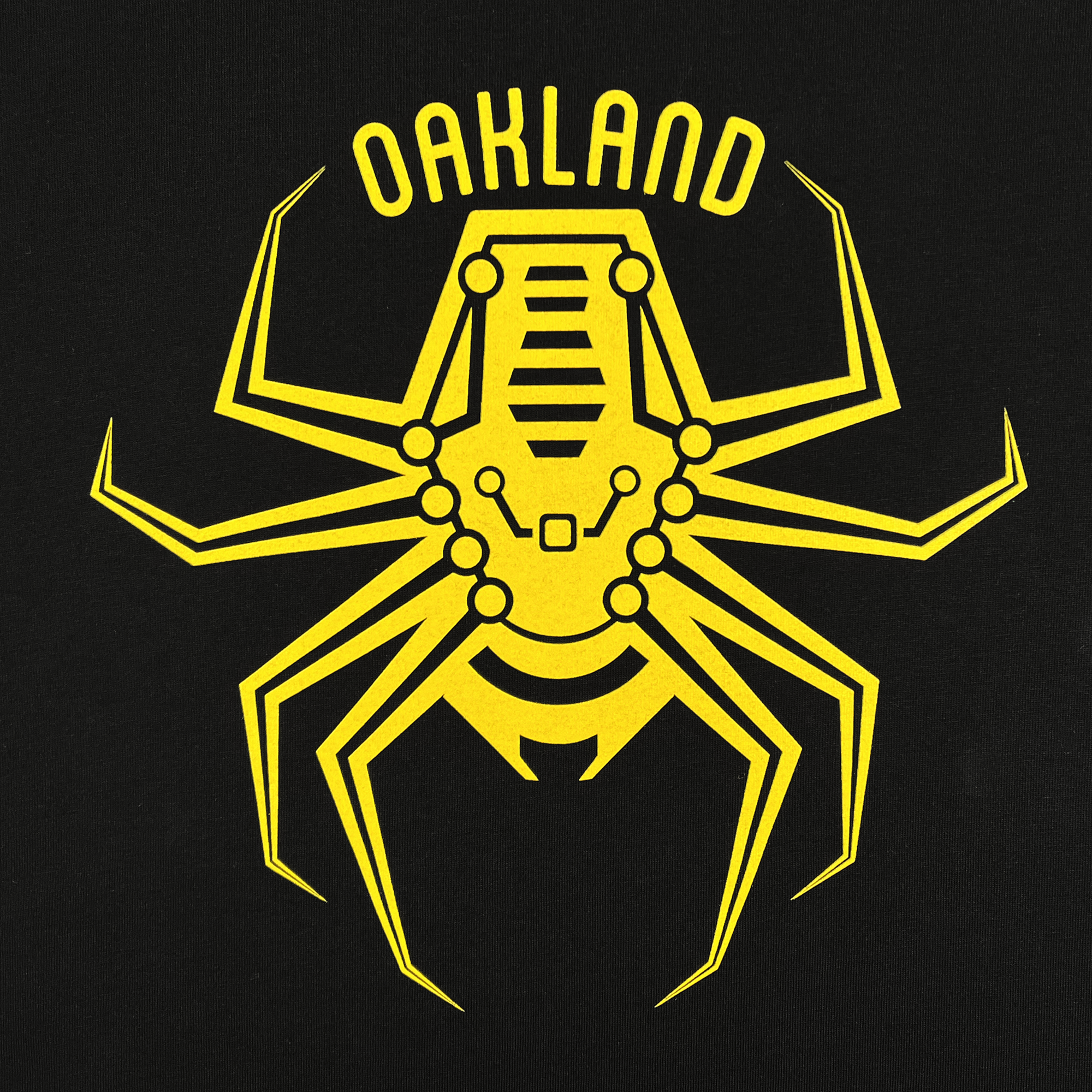 A stylized yellow graphic of a spider-like robot is printed on a black background. Above the robotic creature, the words "Oakland Spiders" curve in bold yellow letters, celebrating the Ultimate Frisbee team. The design incorporates mechanical details that give the spider a futuristic, mechanical appearance, featured on the Oakland Spiders Logo Zip by Supported Brands.