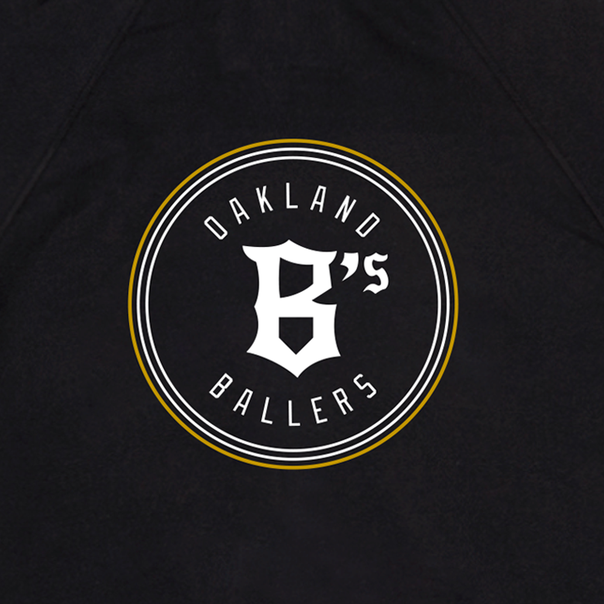 The Oakland Ballers Logo Zip showcases a circular logo featuring "OAKLAND BALLERS" text around the circumference. At the center is a prominent stylized "B's" in white. The circle is bordered by two thin white lines with a yellow accent, all set against a black background, paying homage to their Pioneer League heritage.