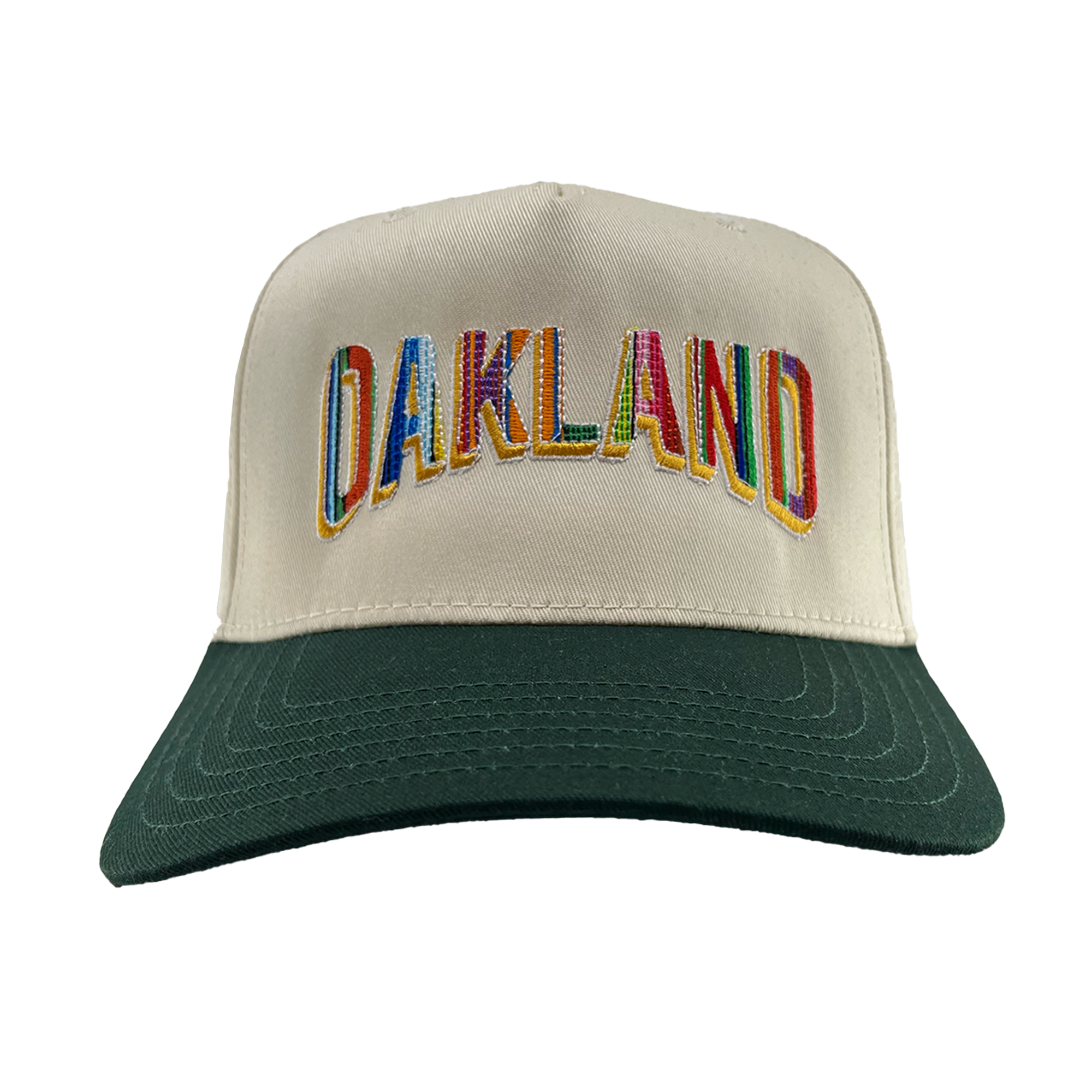 The Oakland Beisbol 5 Panel Cap by Oakland Ballers features a cream design with a dark green bill and bold, multicolored “OAKLAND” embroidery on the front—celebrating the Oakland Ballers Pioneer League team.