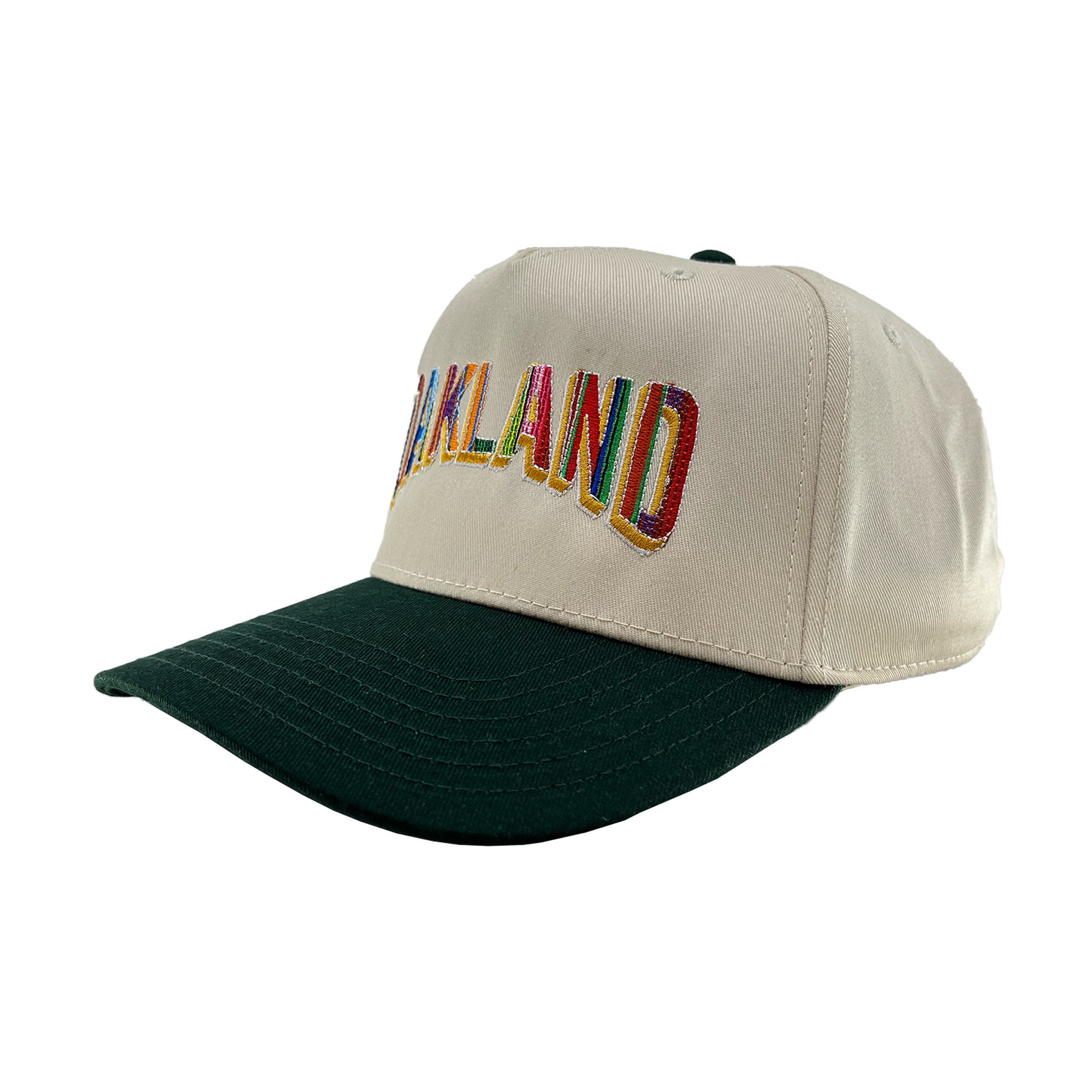 The Oakland Ballers’ Oakland Beisbol 5 Panel Cap features a cream crown, dark green brim, and “OAKLAND” boldly embroidered in multicolor—celebrating the city’s vibrant spirit and its Pioneer League baseball team.
