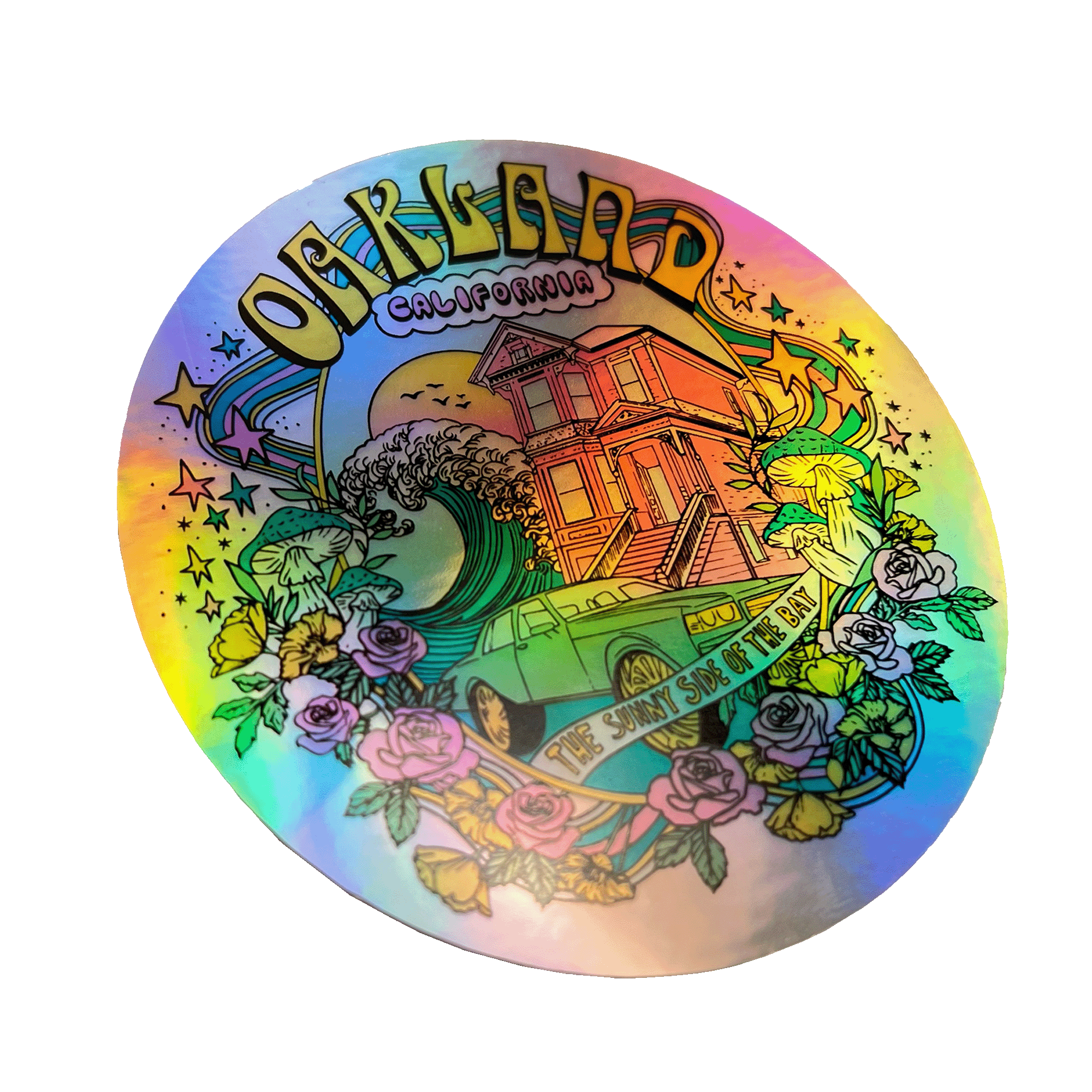 The Oakland Dream Holo Sticker by Oaklandish features a vibrant, detailed illustration of a wave crashing near a Victorian-style house and a vintage van with surfboards. Flowers and leaves surround the scene. The text reads "Oakland California" at the top and "The Sunny Side of the Bay" below the van—perfect for your collection of stylish accessories.