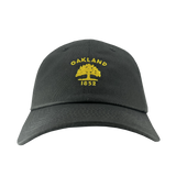 Front view of dark grey cotton dad hat with yellow embroidered Oakland Flag 1832 logo on the crown. 