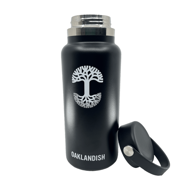 Black stainless steel 32 oz water canteen with white Oaklandish wordmark, logo, and black screw top lid removed and sitting beside.