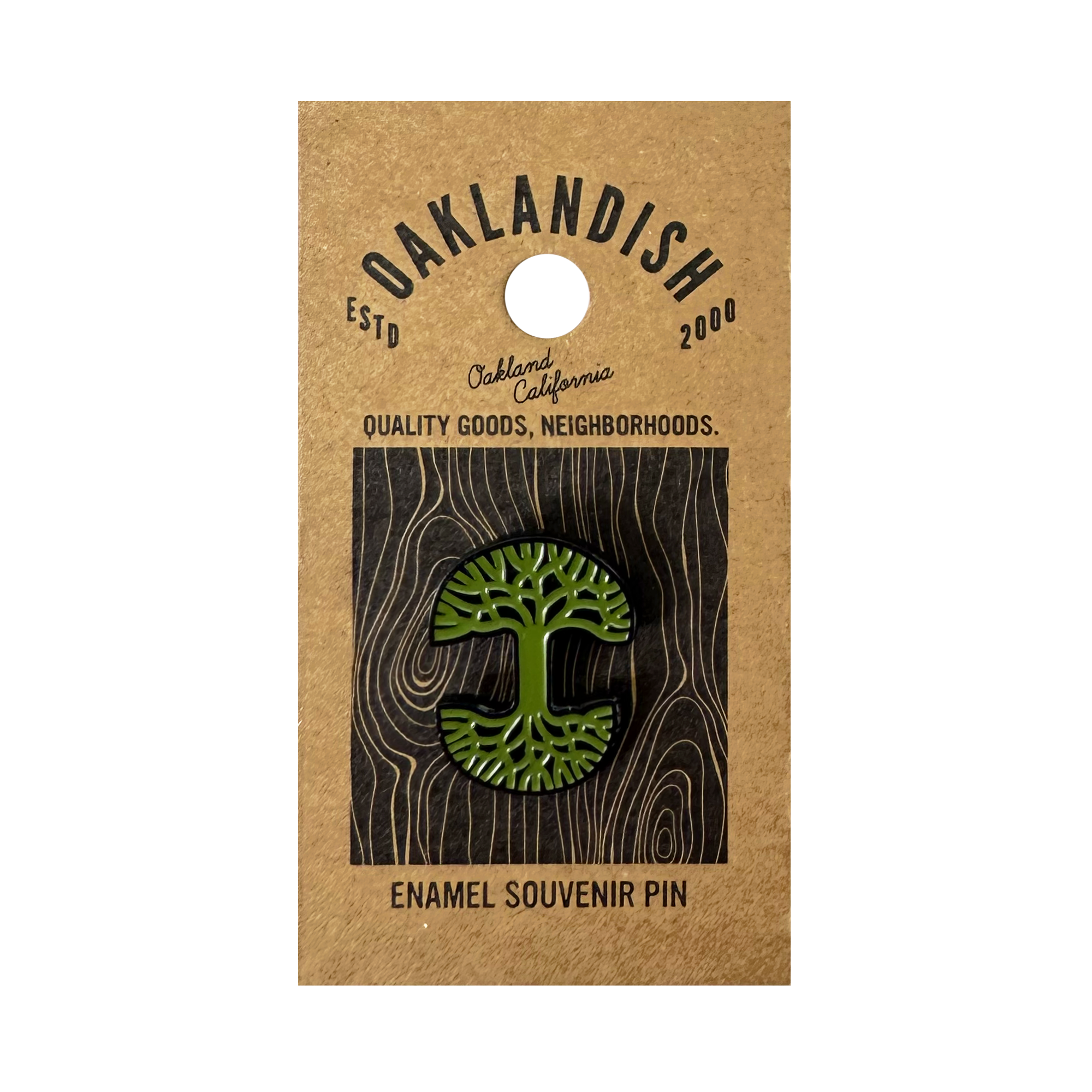 The Oaklandish Logo Enamel Pin, a green enamel accessory shaped like the iconic Oaklandish tree, is attached to brown backing reading "Oaklandish," "Oakland, California," "Quality goods, neighborhoods," and "Enamel Souvenir Pin.