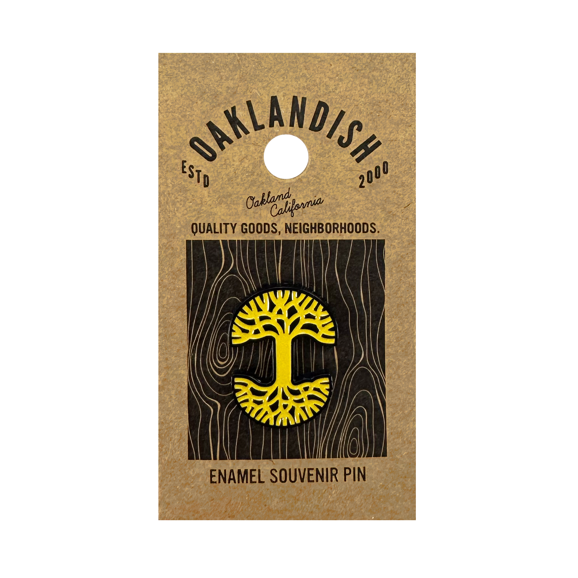 The Oaklandish Logo Enamel Pin is a yellow tree-shaped accessory with black details, attached to a brown card reading "Oaklandish ESTD 2000, Oakland California, Quality Goods, Neighborhoods. Enamel Souvenir Pin.