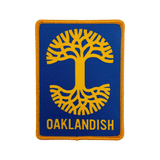 Royal blue woven iron-on patch with gold Oaklandish tree logo and wordmark.