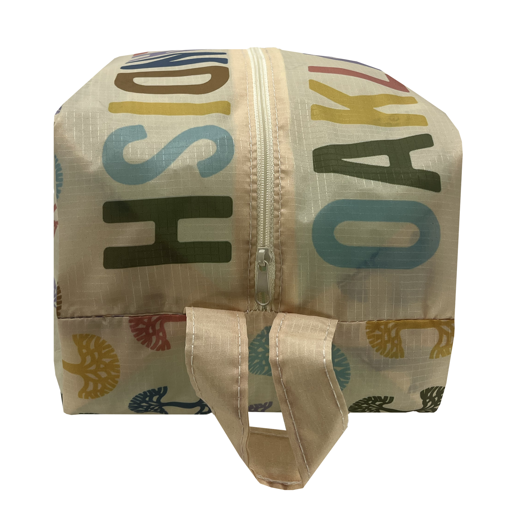 Front view of a natural cream-colored zippered toiletry dopp bag with multi-color Oaklandish tree logos on repeat and Oaklandish wordmarks on the top.
