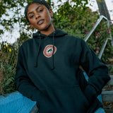 Front angle of female model wearing Educate to Liberate black hoodie with Panther power emblem at front center.