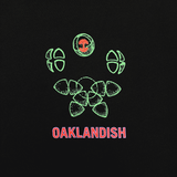 Close-up of green and red Oaklandish worldwide graphic on the left chest wear side.