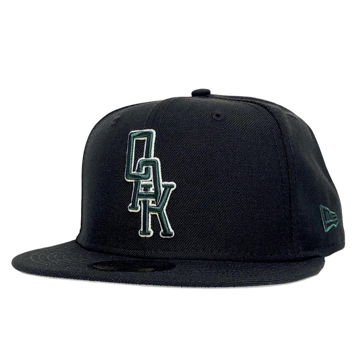 The New Era OAK 59FIFTY Fitted Cap by Other features a black design with “OAK” embroidered in green and white on the front panel. The left side showcases the New Era logo stitched in green. The cap is displayed against a plain white background.
