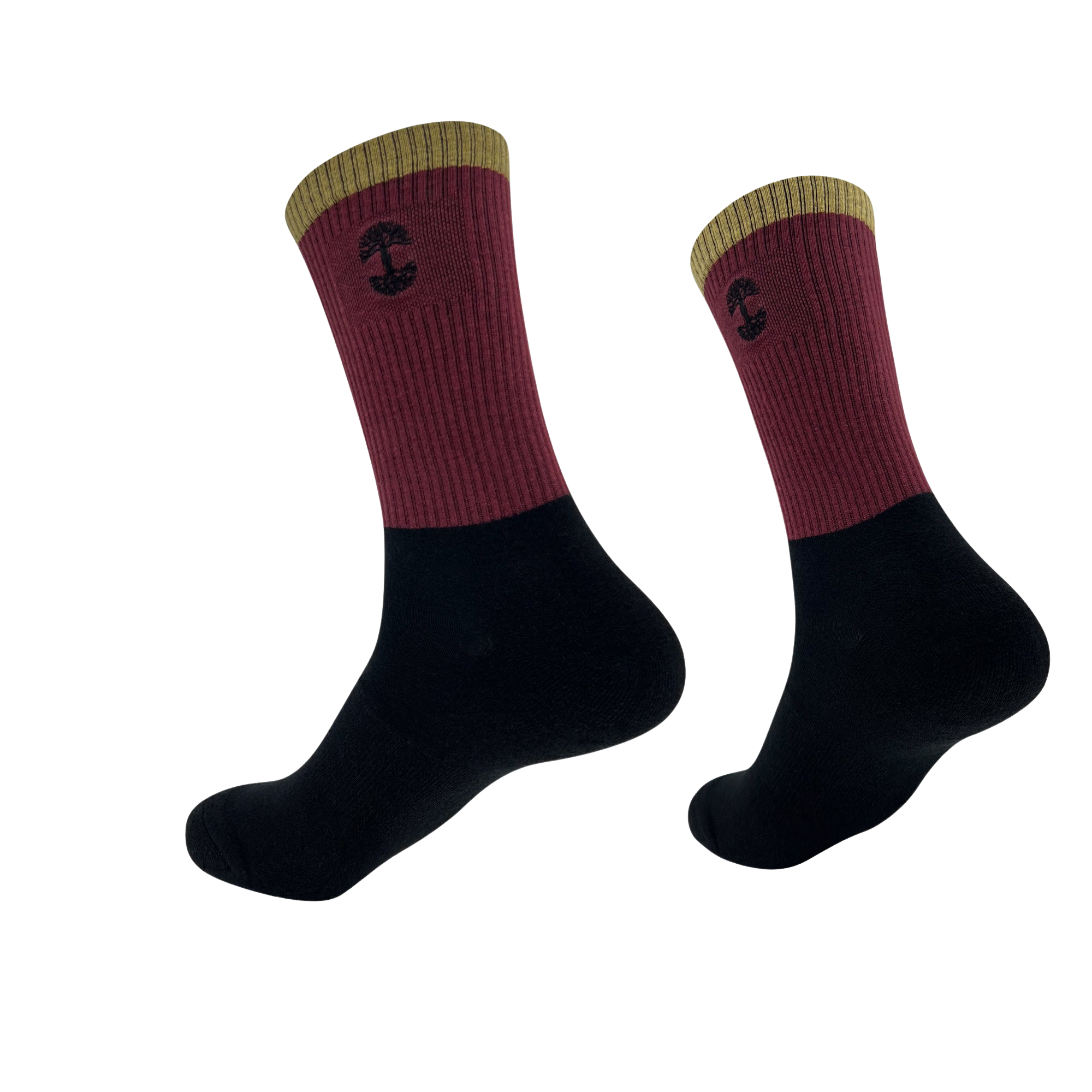 A pair of Oaklandish Colorblock socks features a two-tone design: the top half is burgundy with a yellow cuff and a small black mushroom emblem, and the bottom half is black. The socks are depicted against a plain white background, showing both side and bottom views.