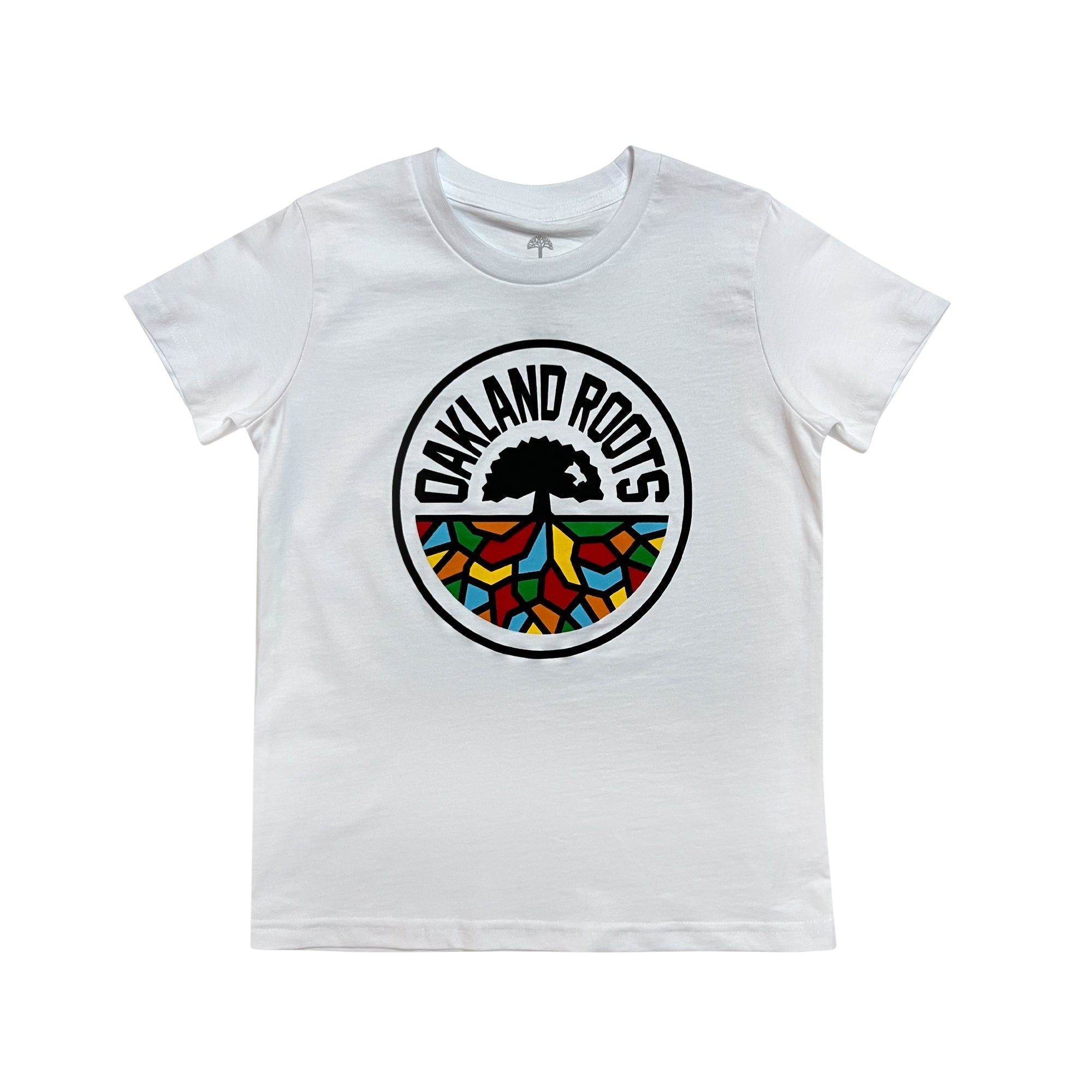 The Youth Oakland Roots SC Classic Tee by Oakland Roots SC is a white short-sleeve t-shirt featuring a colorful emblem in the center. The circular emblem includes a black silhouette of a tree with the words "Oakland Roots" curving around the top. The lower section of the emblem contains a mosaic of vibrant colors: red, yellow, green, and blue, reflecting their commitment to social good.