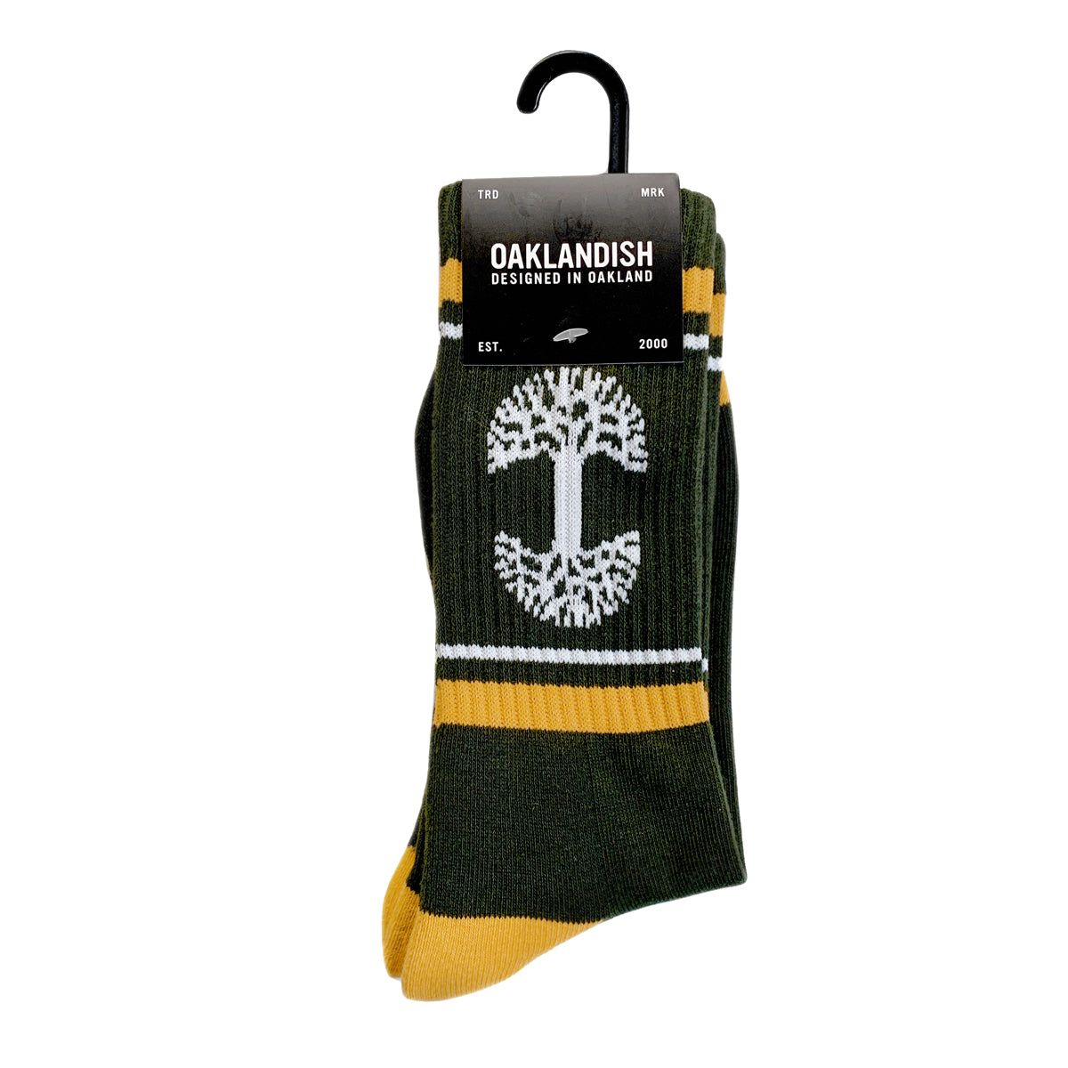 Introducing the OAK Knit Crew Socks by Oaklandish, a stylish pair crafted in forest green with yellow accents and adorned with a white tree design at the center. Made from a comfortable blend of cotton, polyester, and spandex, these crew socks also showcase the Oaklandish logo. They come packaged with a sleek black label that reads "OAKLANDISH - Designed in Oakland - Est. 2000," and include a convenient plastic hanger for easy display.