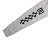 Close-up image of right sleeve of grey long-sleeve t-shirt with printed black checkered race car-inspired artwork and '00'.