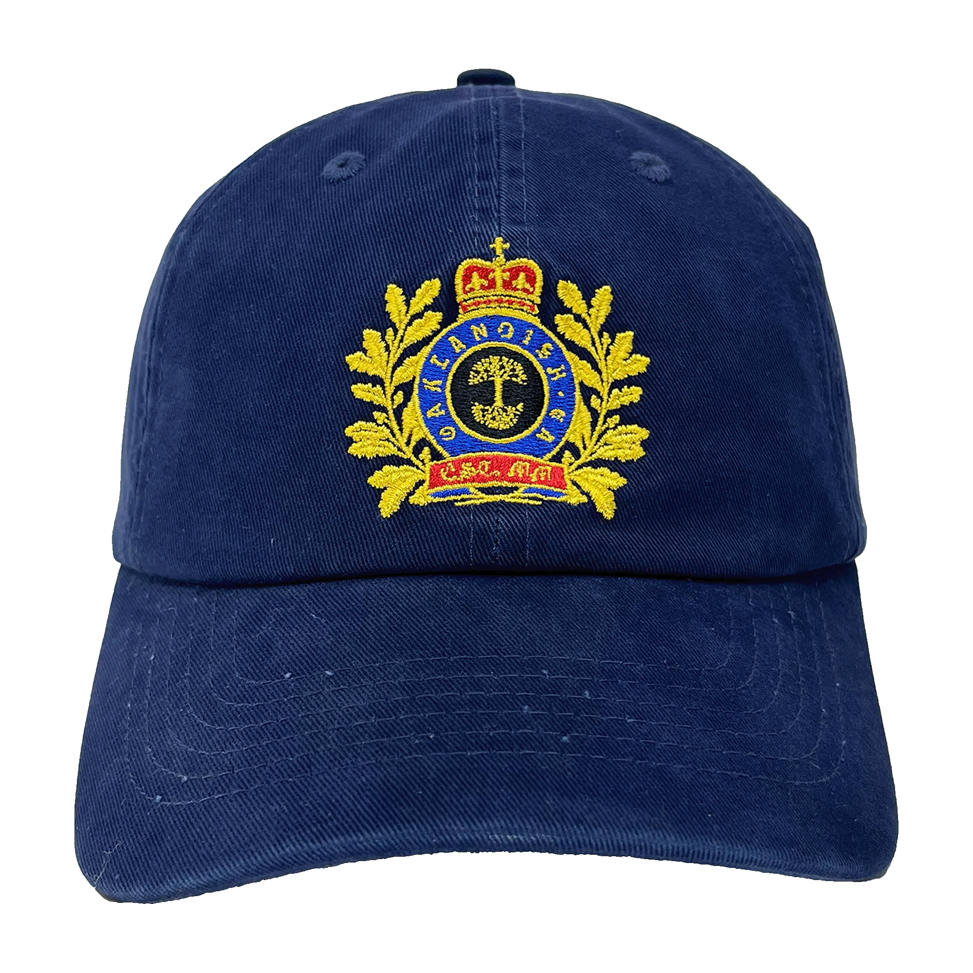 The Regal Crest Dad Hat by Oaklandish is a navy blue hat featuring an embroidered gold emblem on the front. The intricate design includes a crown at the top, gold laurel wreaths on either side, and a central shield with detailed symbols. Blue text is threaded within the emblem, framed by the wreaths. Made from 100% cotton, it also includes an adjustable strap for added comfort.