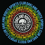 Close-up of Oakland Roots logo and wordmark surrounded by Oakland Roots Sports Club wordmark on repeat in a rainbow circle on a black t-shirt.