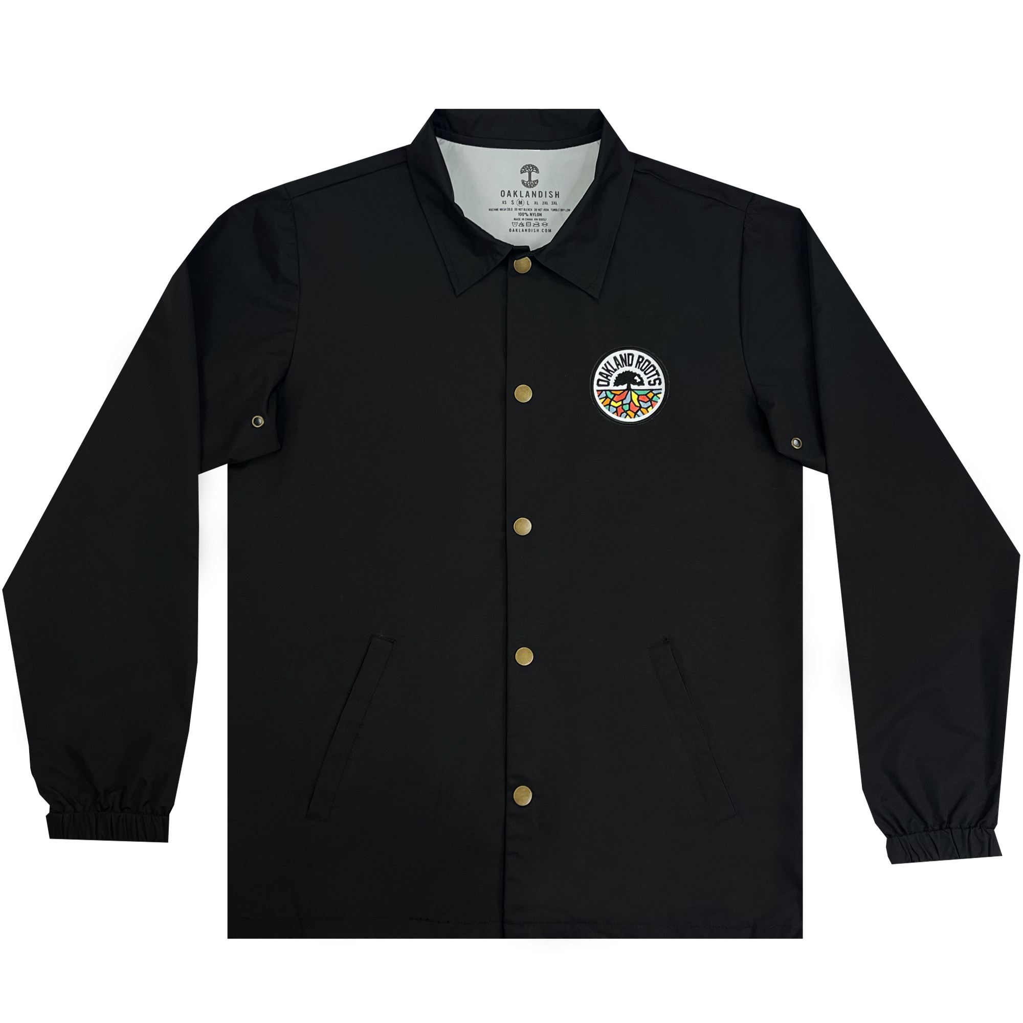The Oakland Roots SC Coaches Jacket by Oakland Roots SC is showcased. This black, water-resistant premium jacket has gold snap buttons, a collar, elastic cuffs, and a logo patch on the left chest area. The circular logo reads "Grand Rhythm" surrounding a colorful design. The interior tag states "Grand Rhythm" and "Diamond Supply Co.