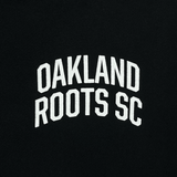 Close up of white OAKLAND ROOTS SC wordmark on the chest of black hoodie.