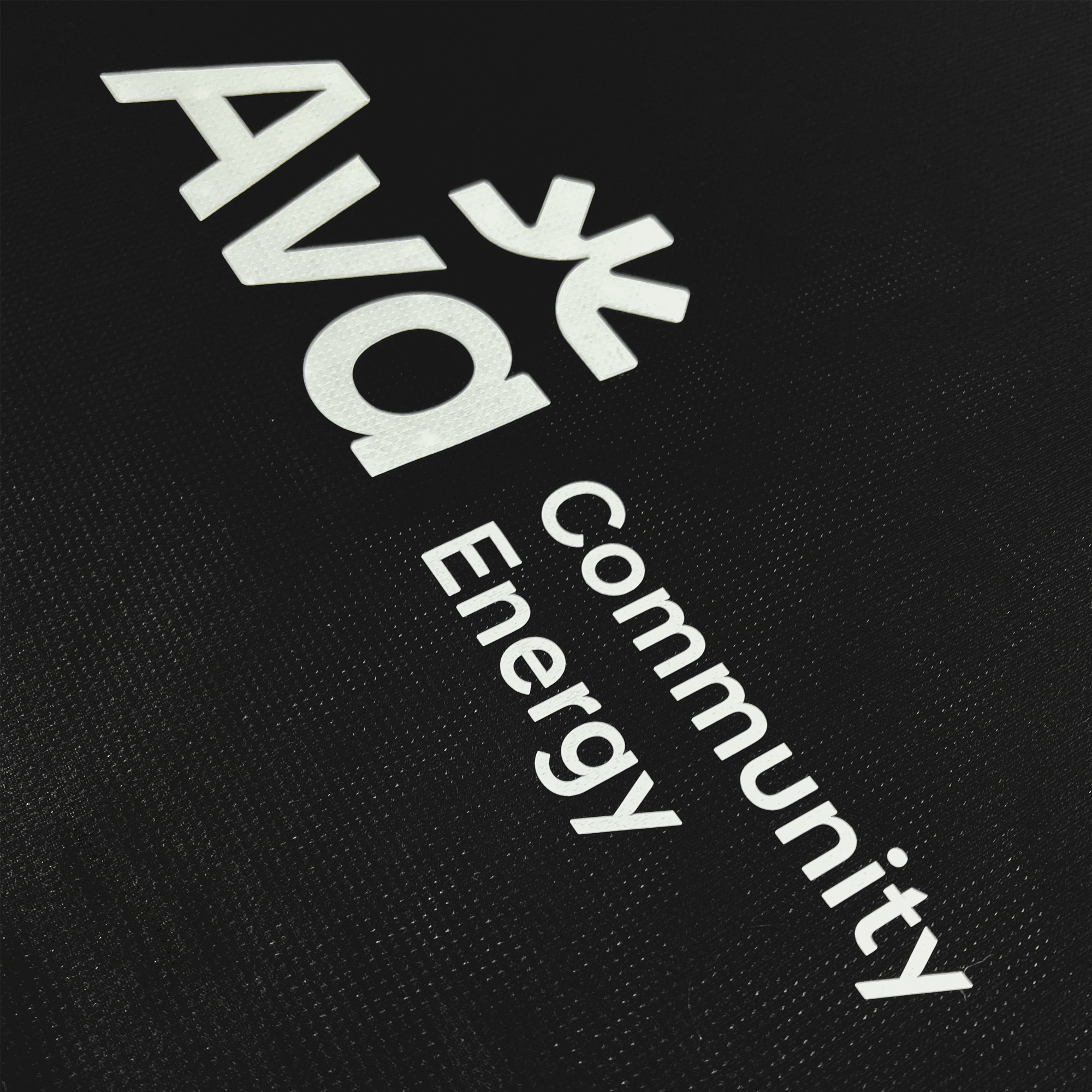 Detailed back view of Ava community energy logo on the back of Oakland Roots SC black jersey.