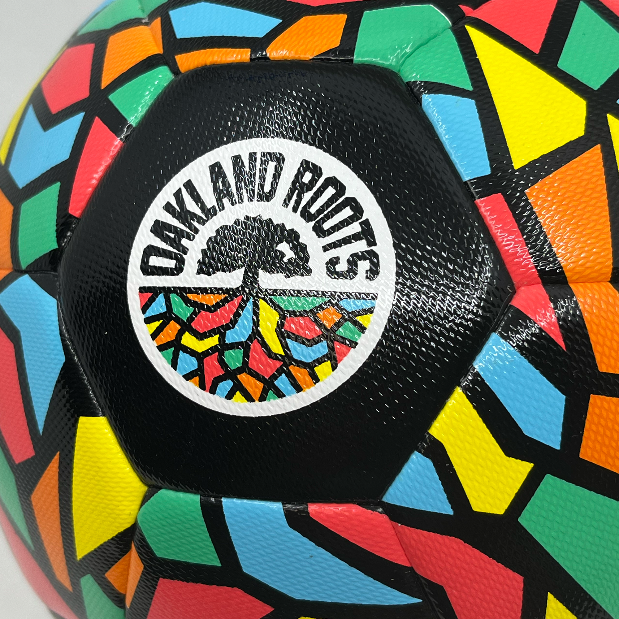 Detail shot of Oakland Roots SC logo on soccer ball.