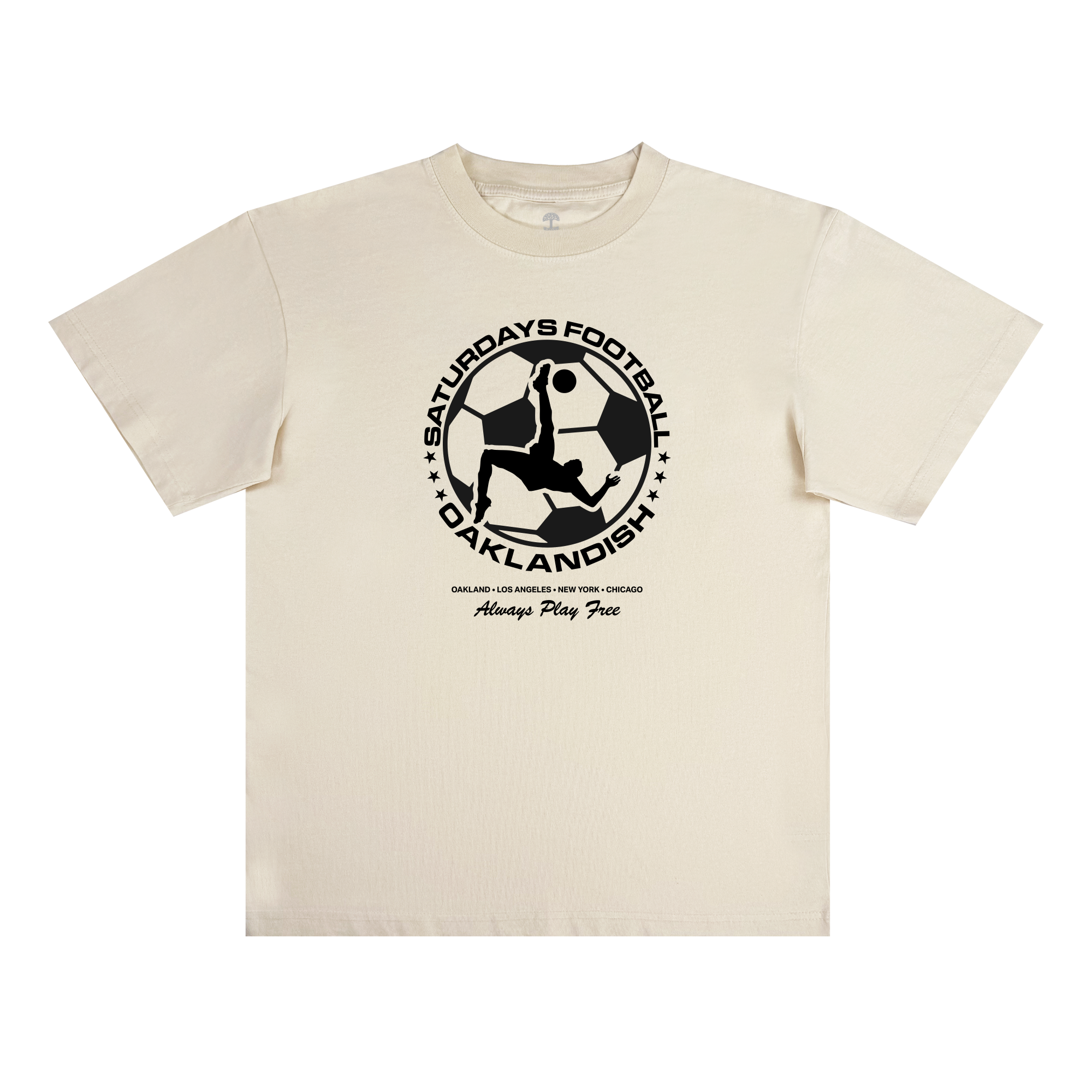 The Oaklandish Saturdays Football Play Free Tee is a classic-fit, cream 100% cotton shirt featuring a bold black soccer graphic, “Saturdays Football OakLandish” headline, and “Always Play Free” with cities like Oakland and NYC below.