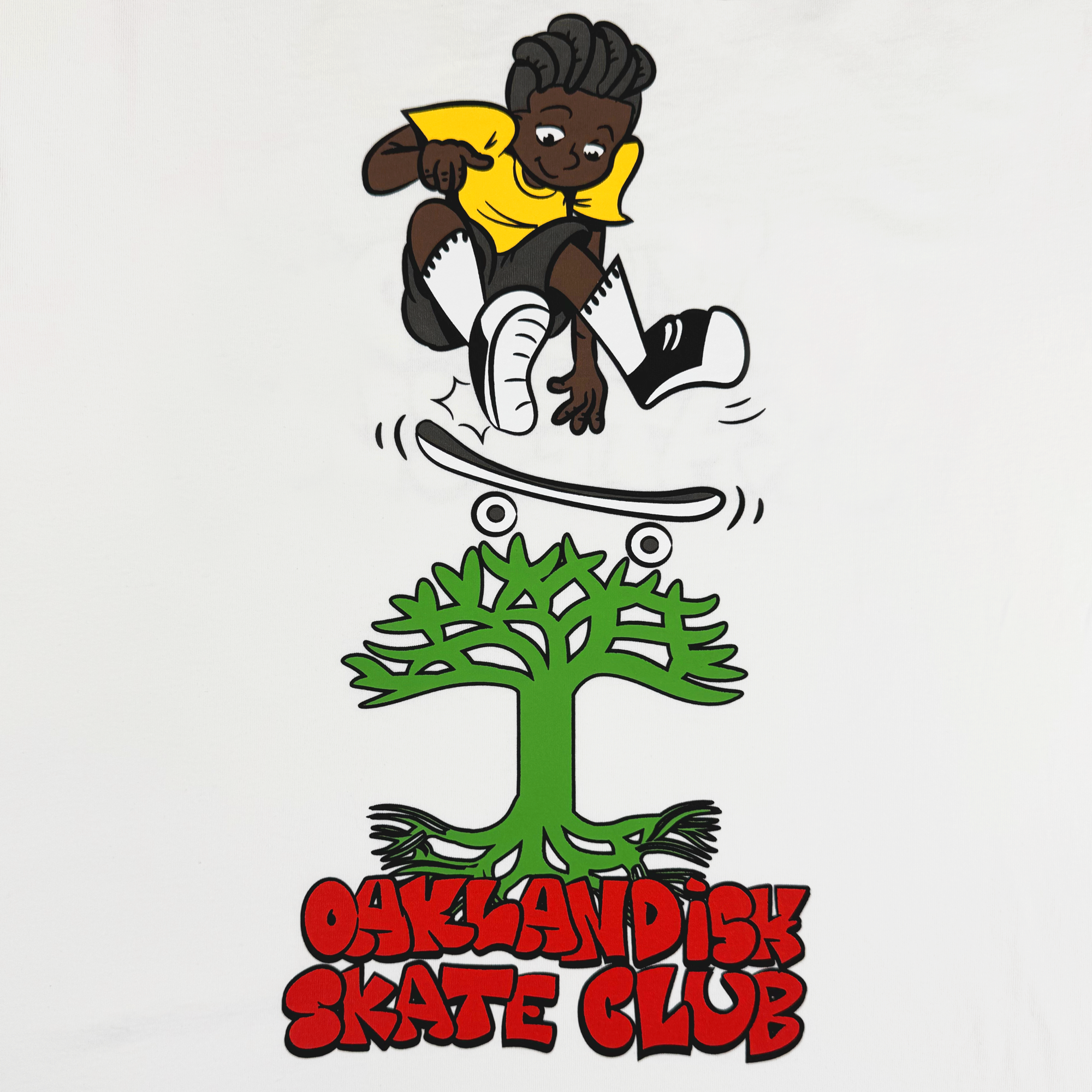 The Oaklandish Skate Club Tee by Oaklandish features a cartoon child with dark skin, black hair, and a yellow shirt doing a skateboard trick over a green tree. Bold red text reads “OAKLANDISH SKATE CLUB” on a plain white background.